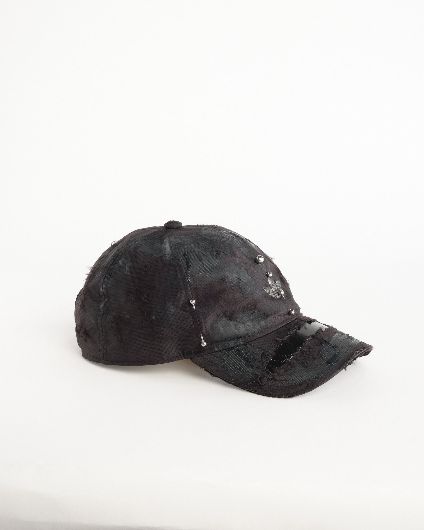 Right side of Black Adidas hat customized by ASTROBOI* with distressing, black painted accents, and stainless steel piercings.