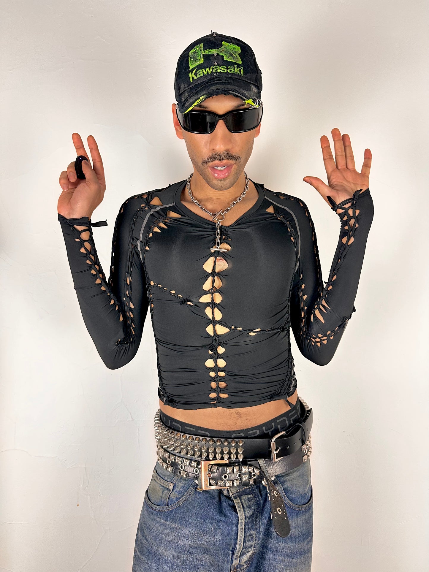 Overview of ASTROBOI* 'Mystique' black braided twist compression top with cut-out details. Handmade in NYC using breathable, moisture-wicking stretch fabric.