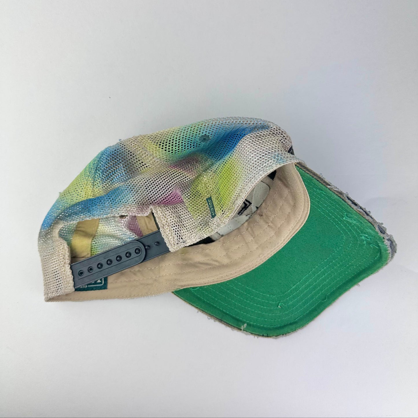 Back on ASTROBOI* EASTON rainbow rhinestone mesh trucker hat with airbrushed confetti design, sparkling logo, and adjustable back strap.