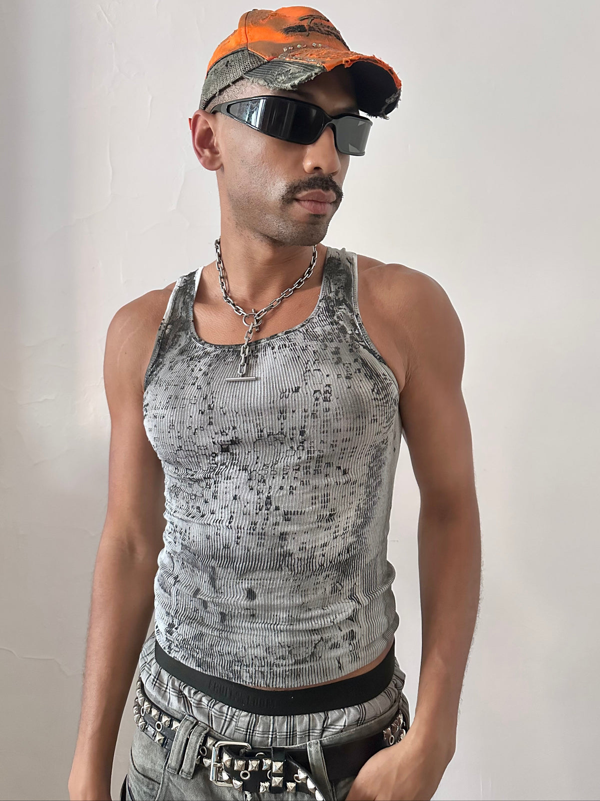 Male model wearing ASTROBOI* x Hanes 'Digi Camo' Y2K black and white ribbed graphic tank top, styled full look, ASTROBOI* STUDIO NYC.