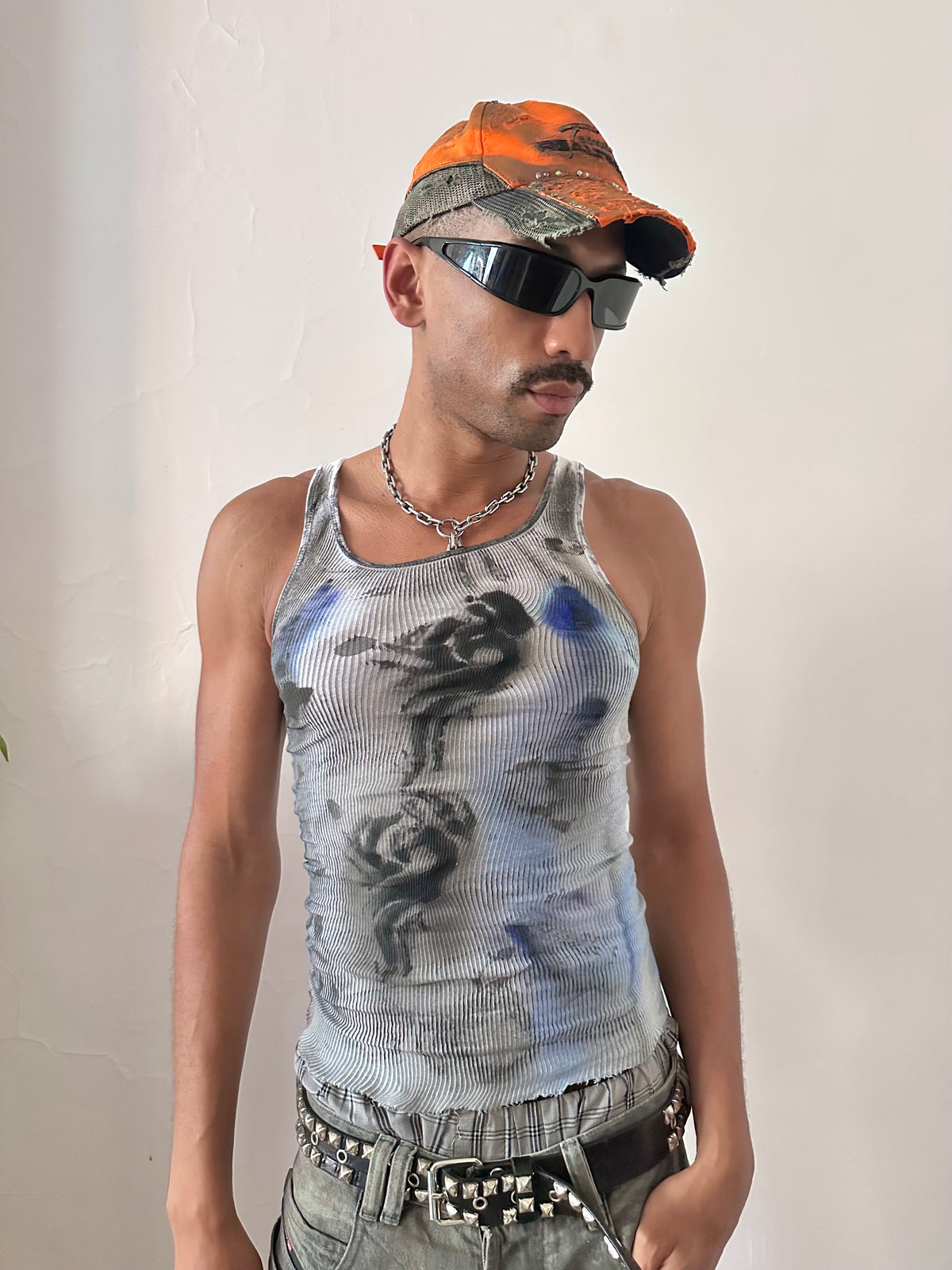Male model wearing ASTROBOI* x Hanes 'Ice Dancer' white, black, and blue ribbed graphic tank top, styled full look, ASTROBOI* STUDIO NYC.