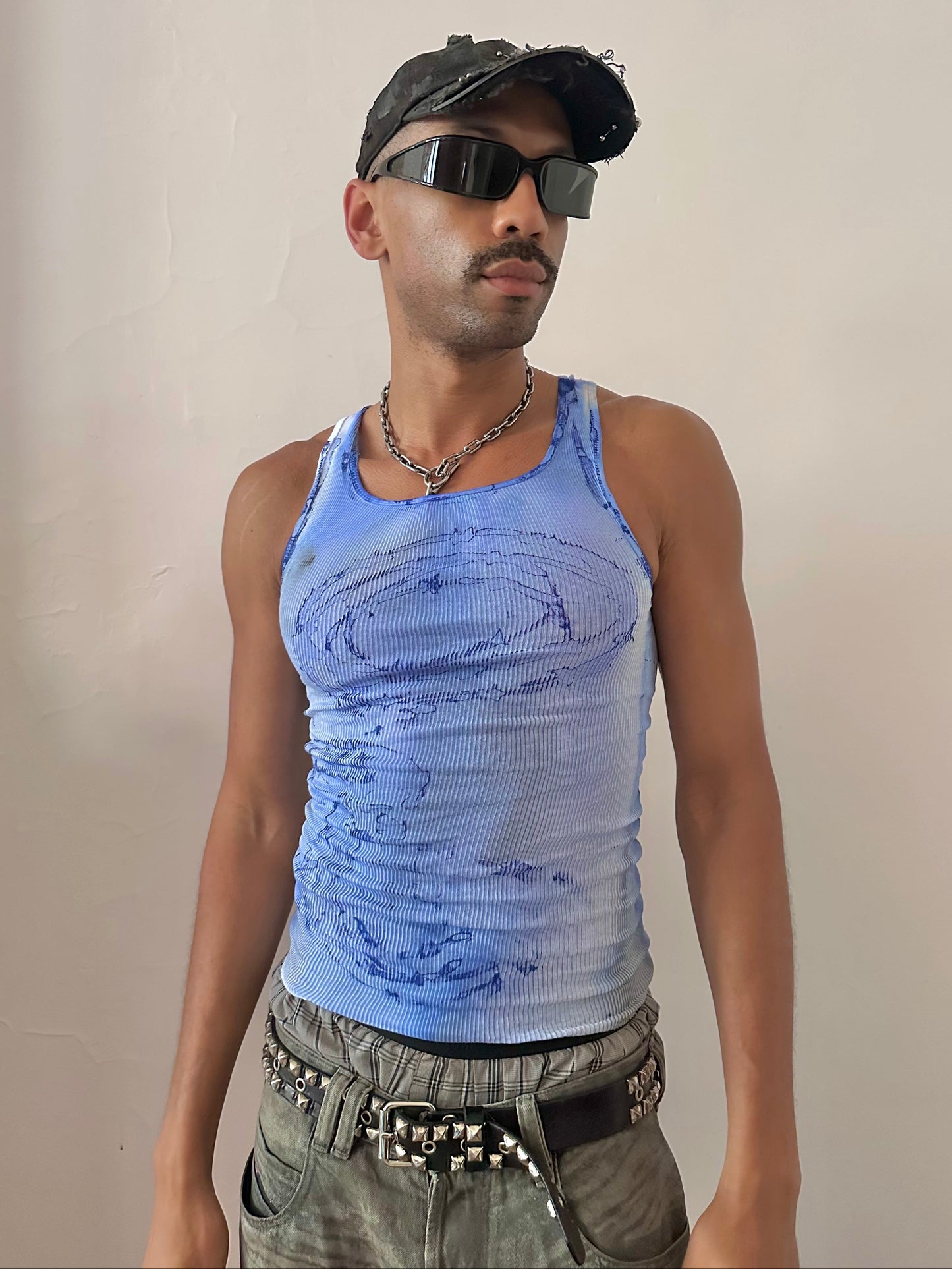 Male model wearing ASTROBOI* x Hanes 'Aero' blue ribbed graphic swirl tank top, styled full look, ASTROBOI* STUDIO NYC.