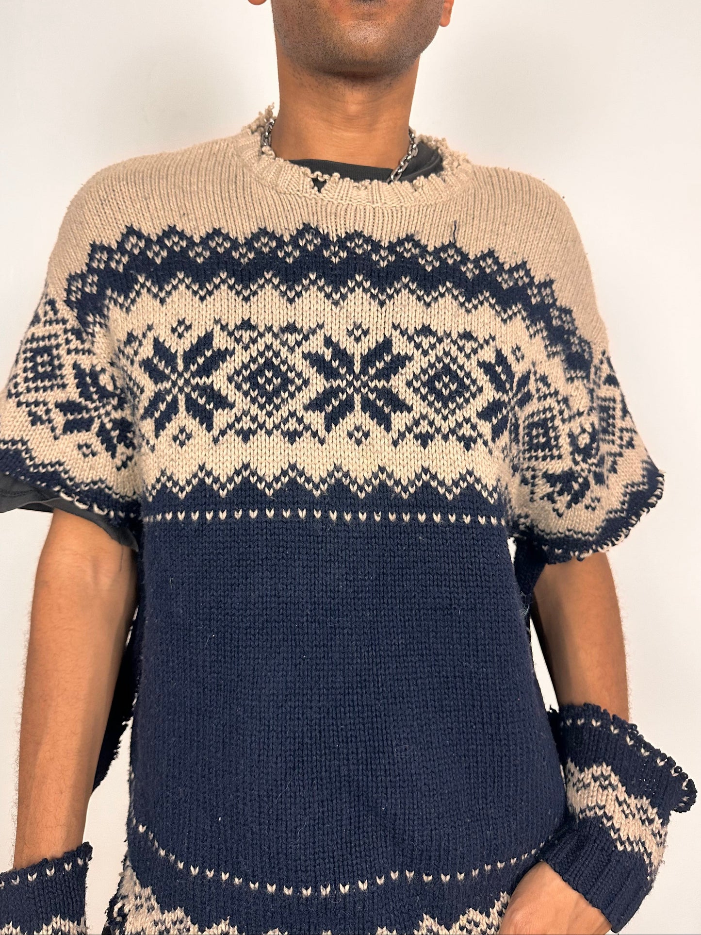 Close up of Deconstructed Fair Isle grunge sweater in XL with boxy fit, cutout sleeves, and raw hem, handmade by ASTROBOI* STUDIO in NYC.