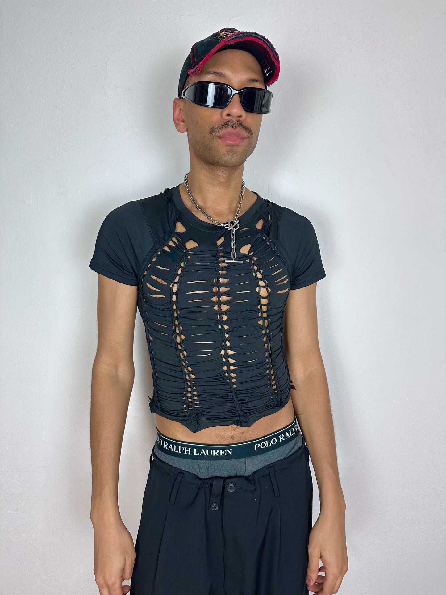 Male model wearing ASTROBOI* 'Lines' black braided compression shirt, styled full look, ASTROBOI* STUDIO NYC.