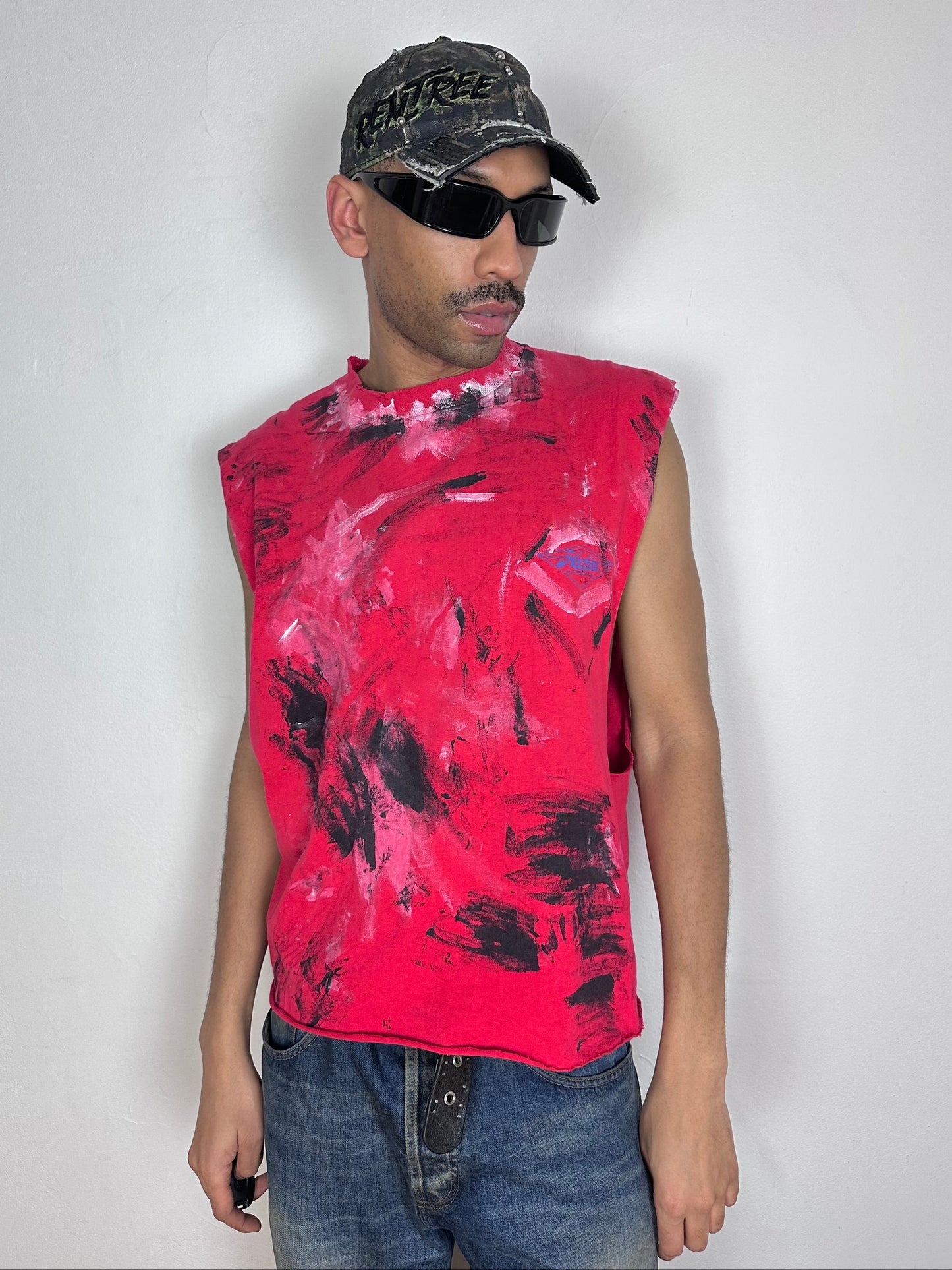 Male model wearing ASTROBOI* 'Hobie' red painterly graphic t-shirt, styled full look, ASTROBOI* STUDIO NYC.