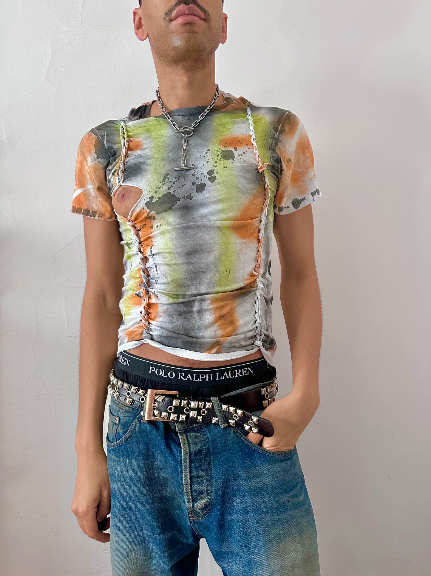 Male model wearing ASTROBOI* x Gildan 'Orange Haze' white multicolored painted graphic t-shirt, styled full look, ASTROBOI* STUDIO NYC.