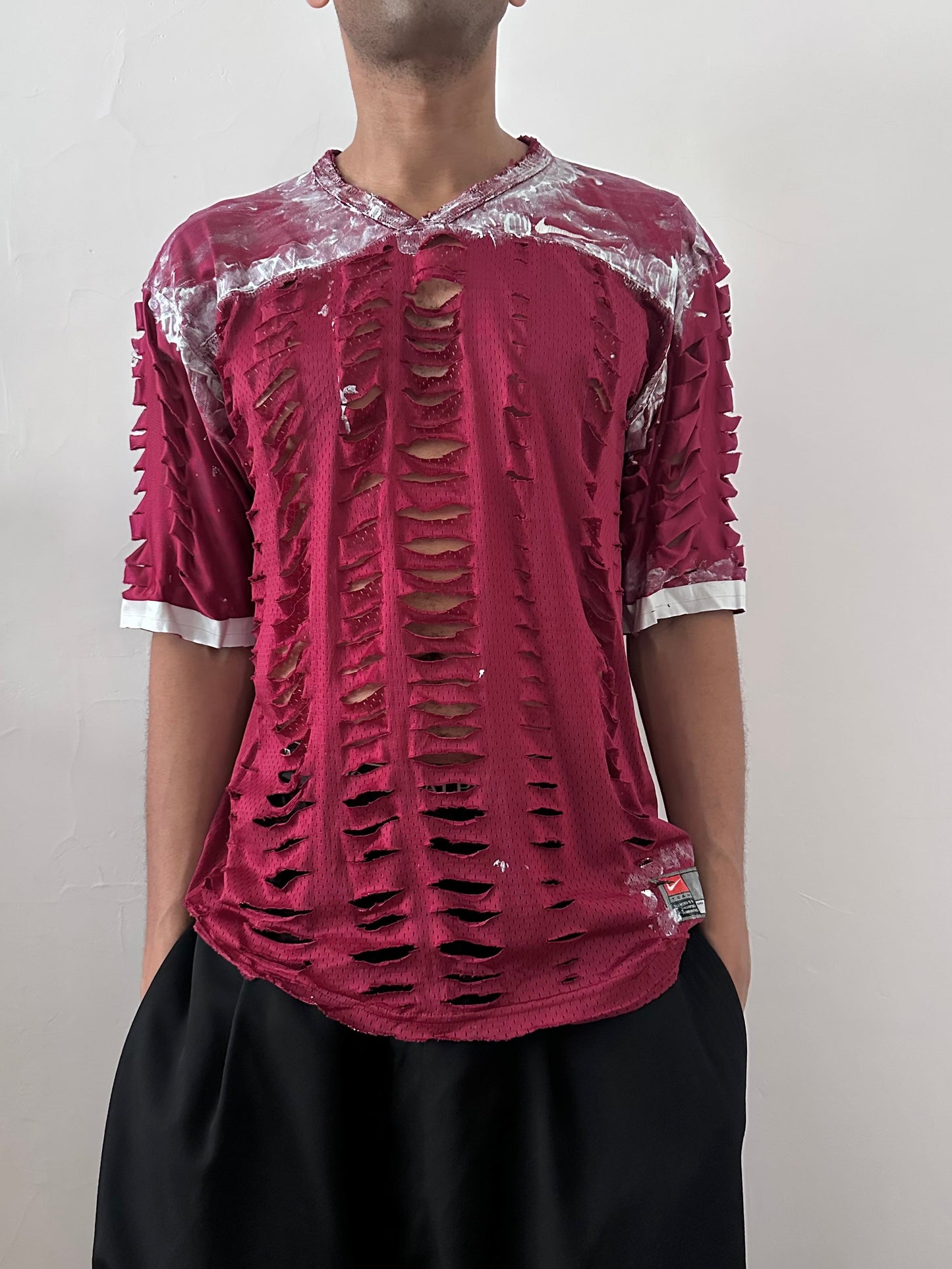 Male model wearing ASTROBOI* x Nike 'BloodThirst' maroon mesh painterly jersey, styled full look, ASTROBOI* STUDIO NYC.