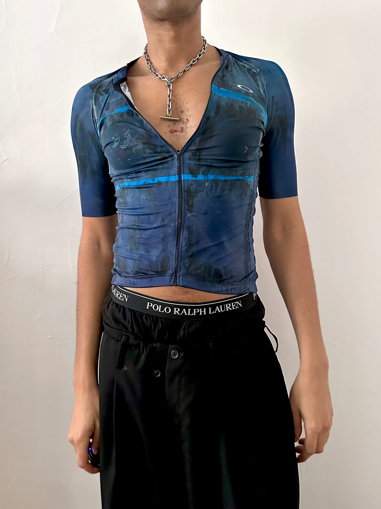 Male model wearing ASTROBOI* x Oakley blue painted cycling jersey, styled full look, ASTROBOI* STUDIO NYC.