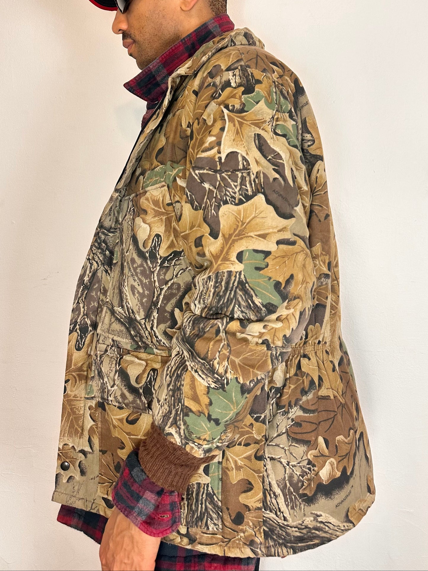 Left side of Vintage brown RealTree camouflage quilted jacket with insulated lining, knit cuffs, four front pockets, boxy fit, size XL.