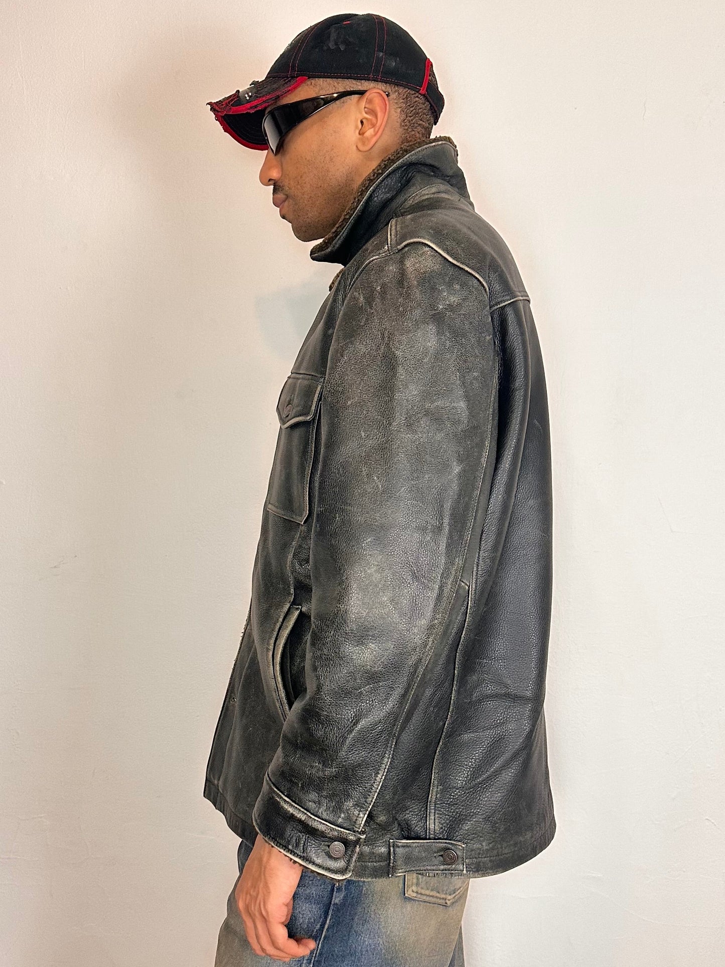 Left side of Vintage GAP blackish-brown leather shearling jacket with sherpa collar and interior, chest and hip pockets, rugged fatigued finish, size XL.