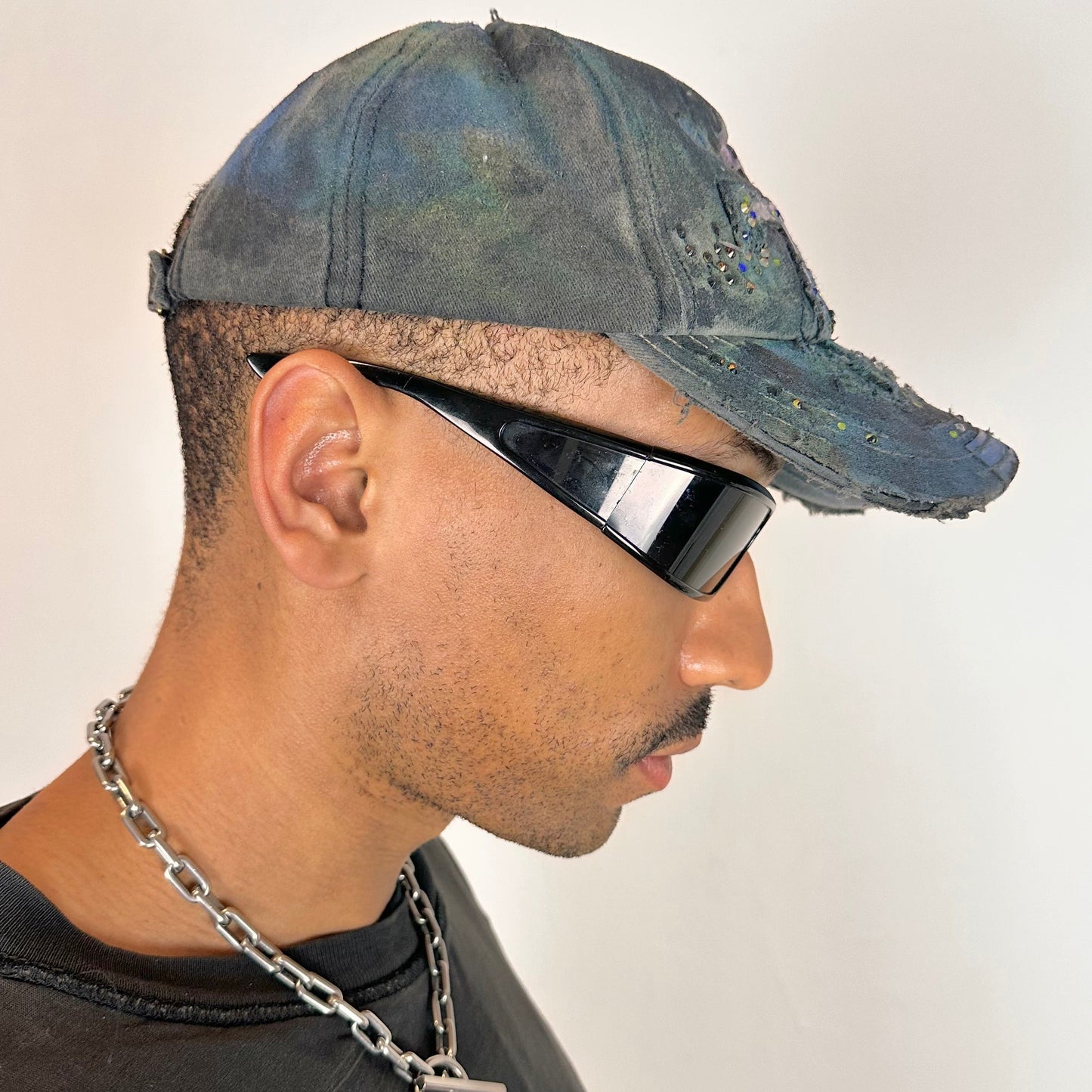 Right side of ASTROBOI* blue rainbow tropical Y2K hat with multicolored rhinestones, hand-painted shading, and adjustable strap back