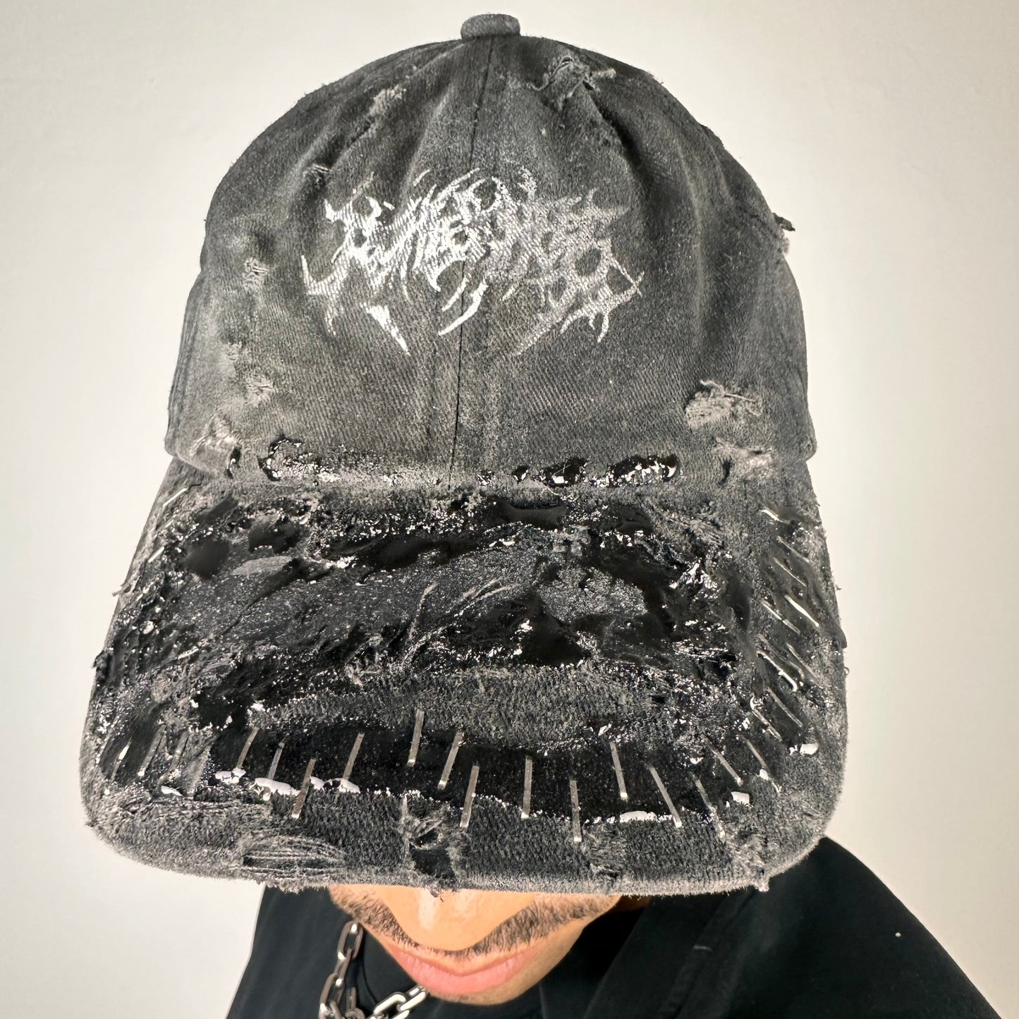 ASTROBOI* Stitched Up black distressed hat with silver staples sealed in resin, indie logo, and custom paint, handmade in NYC.