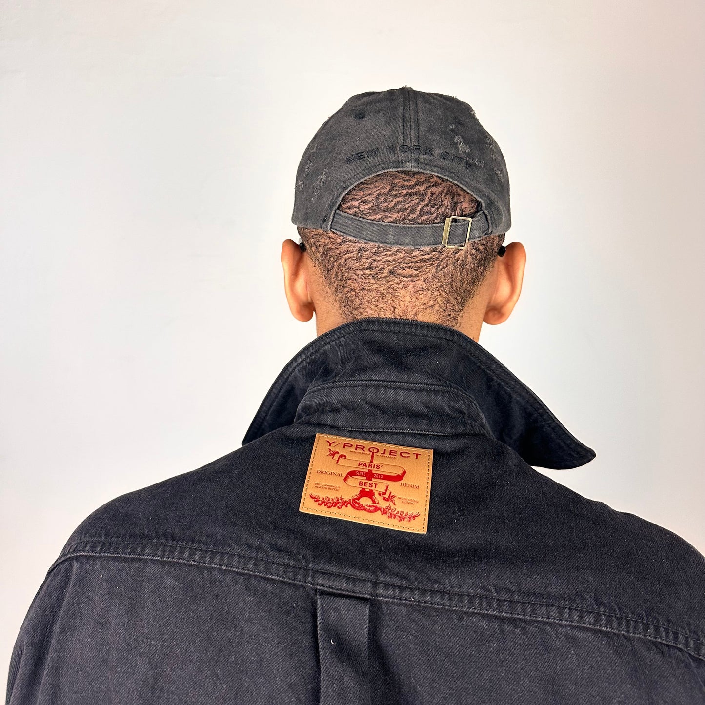 Back of ASTROBOI* 'Kinky' New York Black Distressed Pierced Half Visor Hat - flat detail