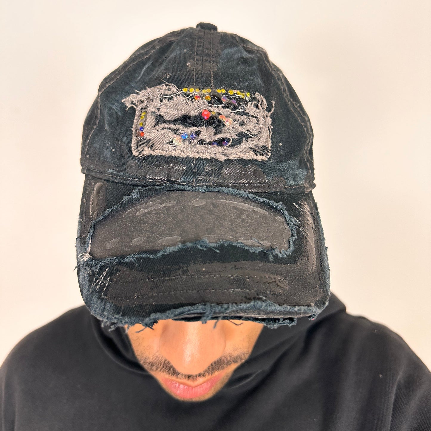 Front of ASTROBOI* New York Aquarium navy distressed baseball hat with resin-sealed rhinestone logo, black waxed paint details, adjustable strap, custom NYC piece