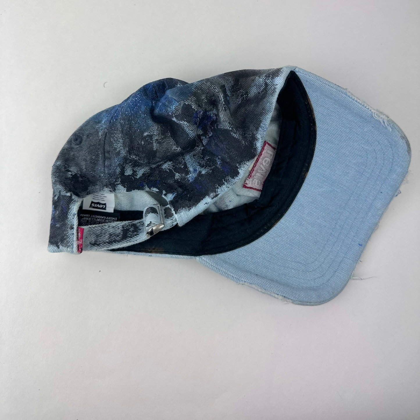 ASTROBOI* x Levi's 'Blacked Out' blue and black grunge denim hat, rear view showing adjustable strap back.