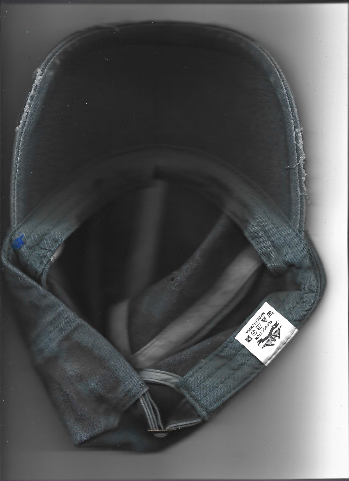 Scanned image of ASTROBOI* 'Slick' showing silver studded visor detail and 3D resin coating on black and gray base, rear view.