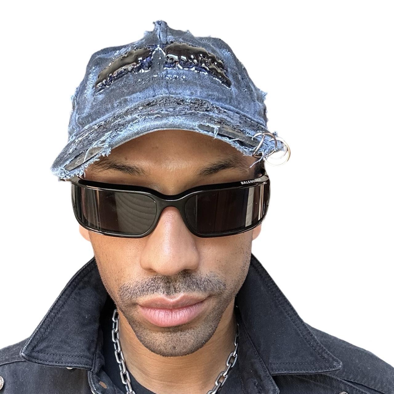 Front overview of ASTROBOI* 'Feeling Blue' distressed blue resin-coated hat with hand-painted black shading, metal piercings on the right front, and New York embroidery, handmade in NYC.