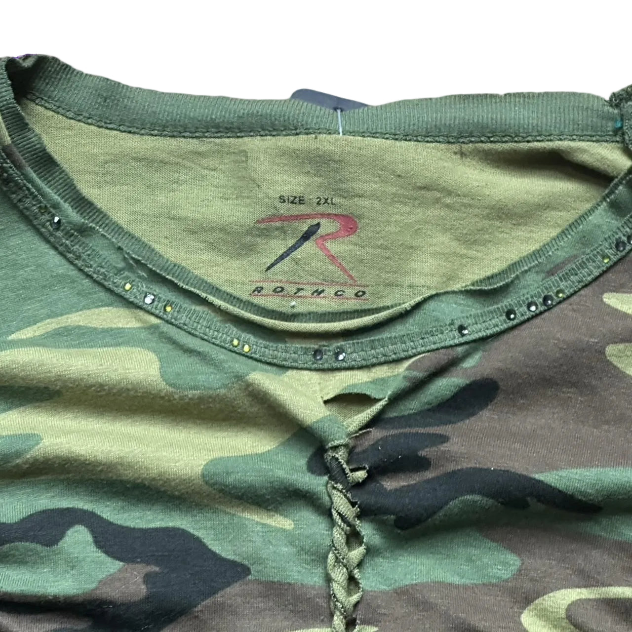 Rhinestone collar detail on ASTROBOI* green camouflage T-shirt with braided detailing, tonal rhinestone collar, raw hem, and loose fit, handmade in NYC.