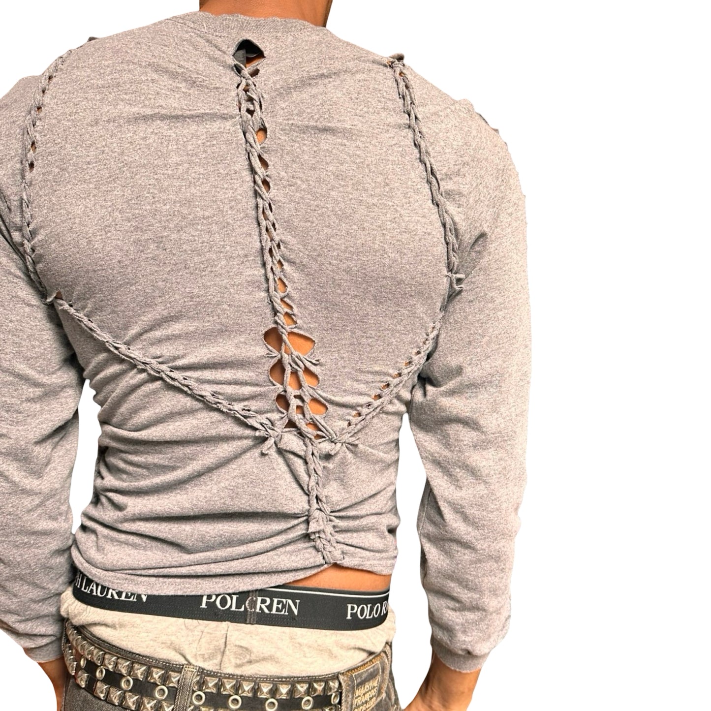 Gray long-sleeve shirt with cut-out braided festival design on the back, worn by a person.