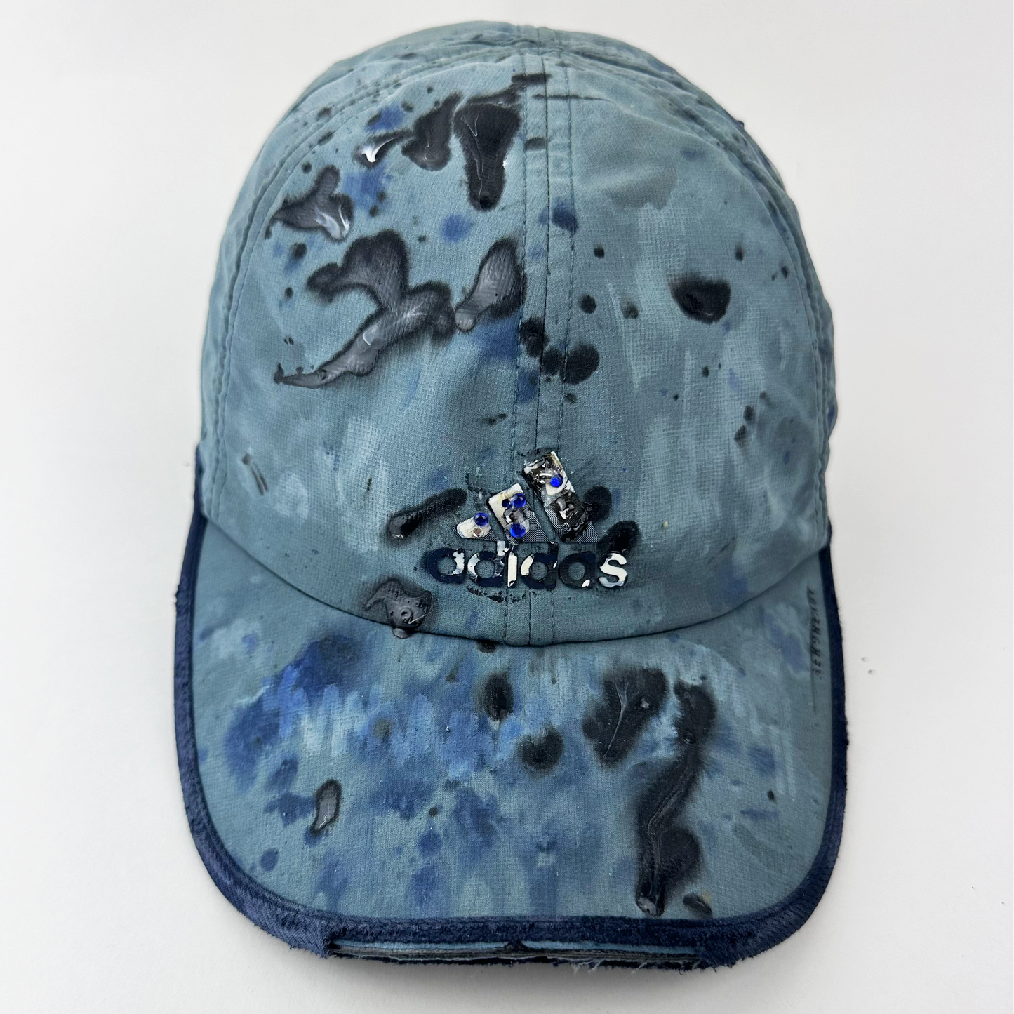 ASTROBOI* x Adidas 'Haaland' blue and black painted Aeroready cap with rhinestone-embellished Adidas logo at front and blue visor trim, front view.