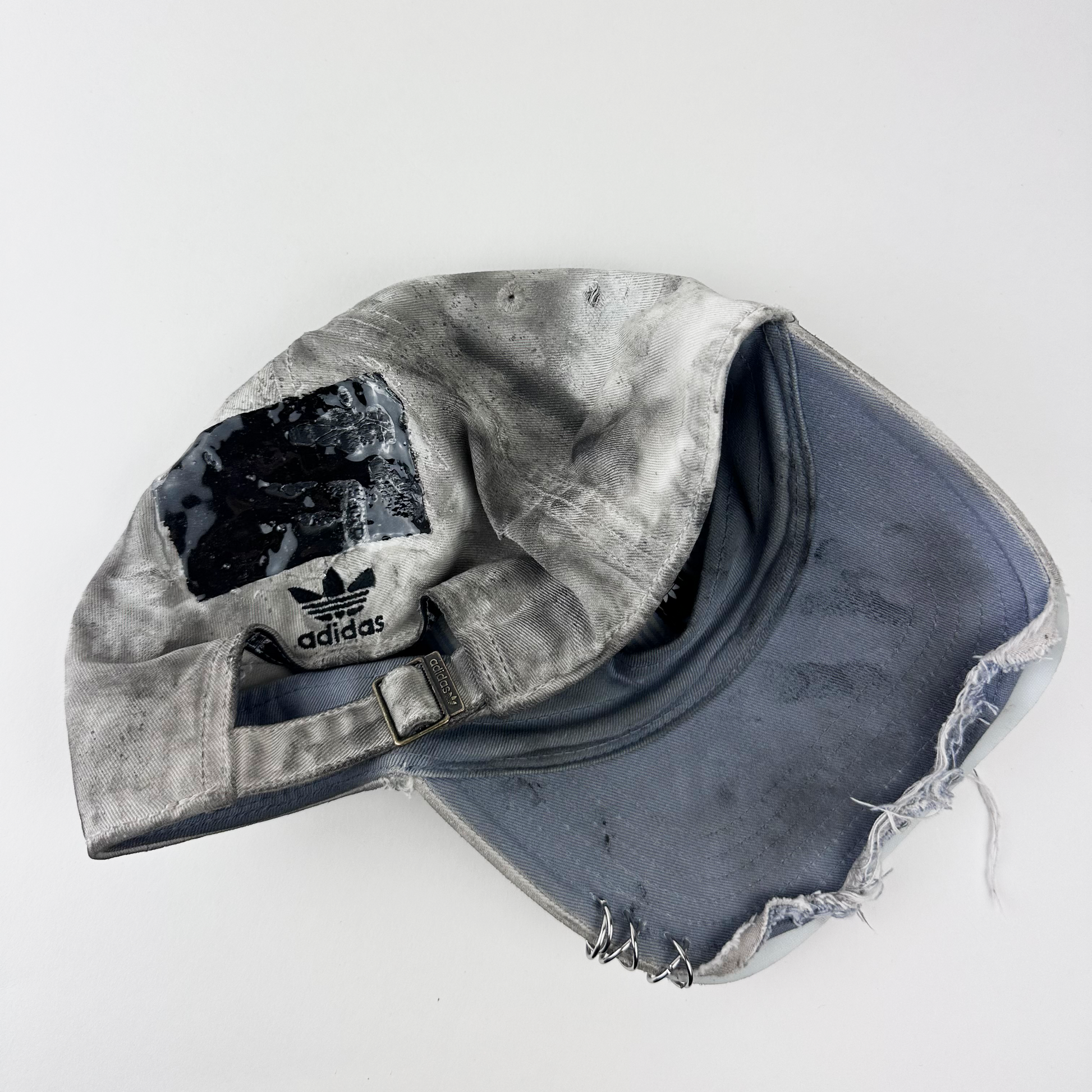 ASTROBOI* x Adidas 'H Chic' tan distressed grunge hat, rear view showing black duct tape accent detail and adjustable strap.