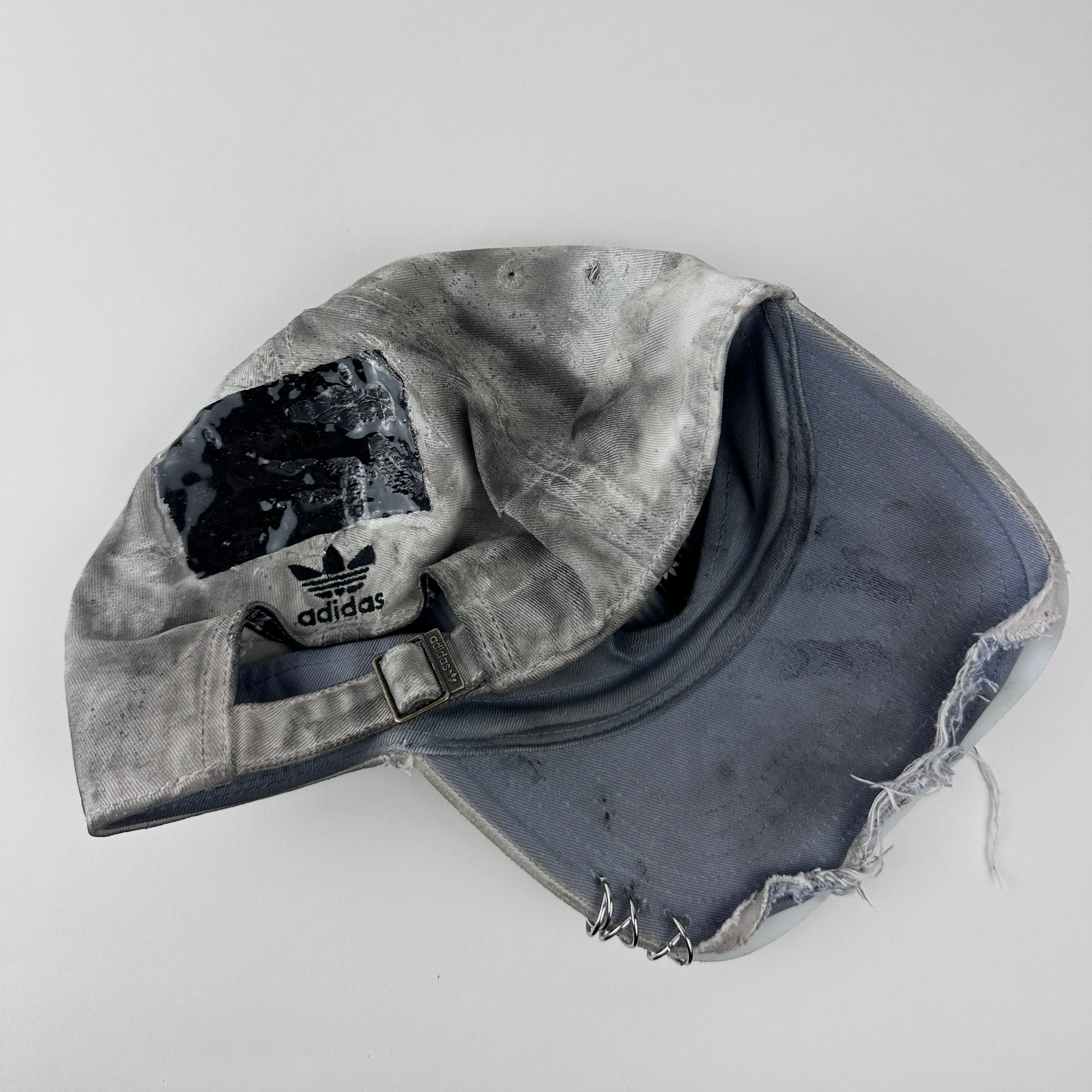 ASTROBOI* x Adidas 'H Chic' tan distressed grunge hat, rear view showing black duct tape accent detail and adjustable strap.
