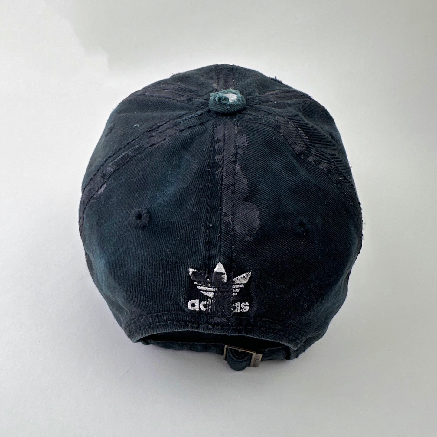 ASTROBOI* x Adidas 'Washed' black distressed faded cap, rear view showing Adidas trefoil back logo and adjustable strap.