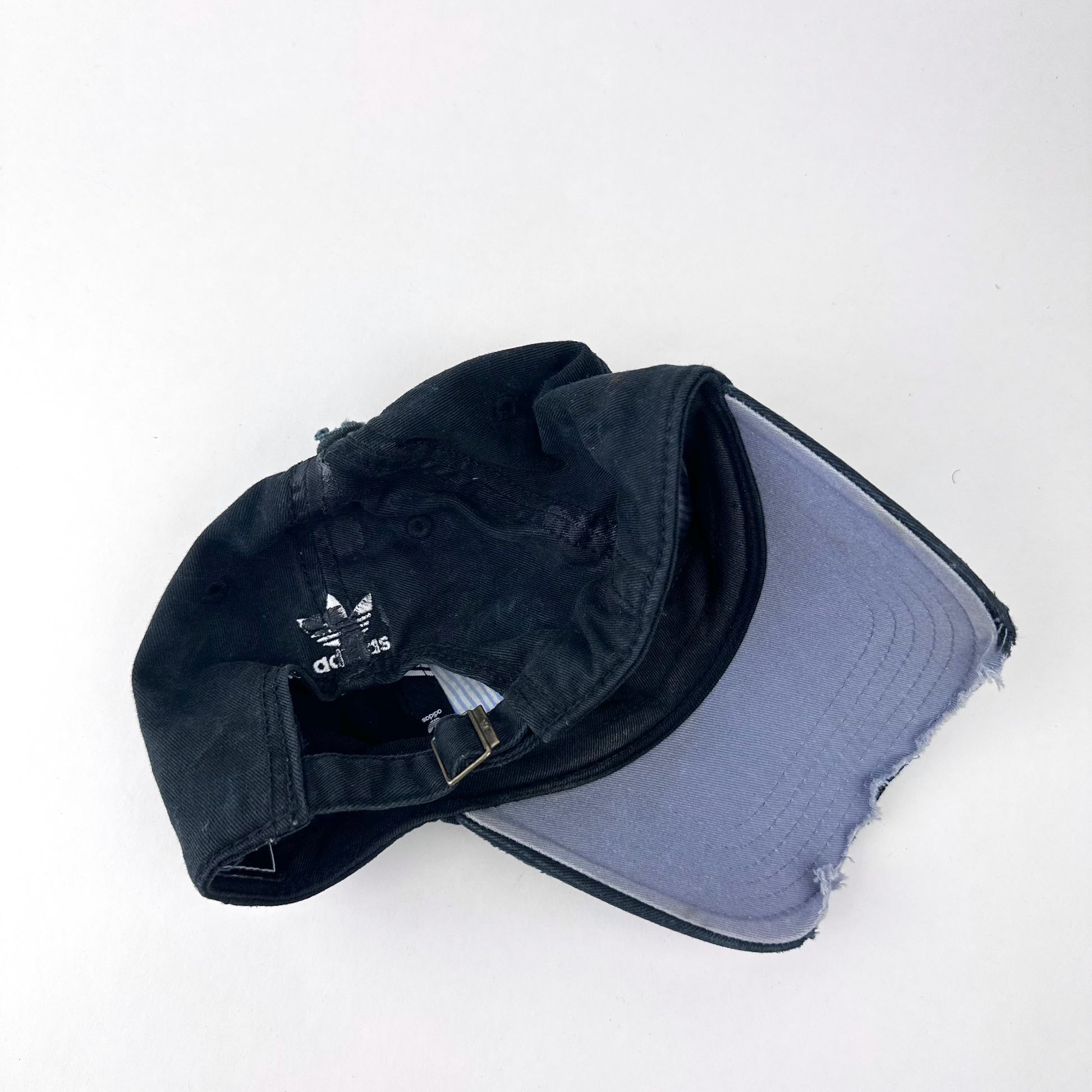 ASTROBOI* x Adidas 'Washed' black distressed faded cap, rear view showing Adidas trefoil back logo and adjustable strap.