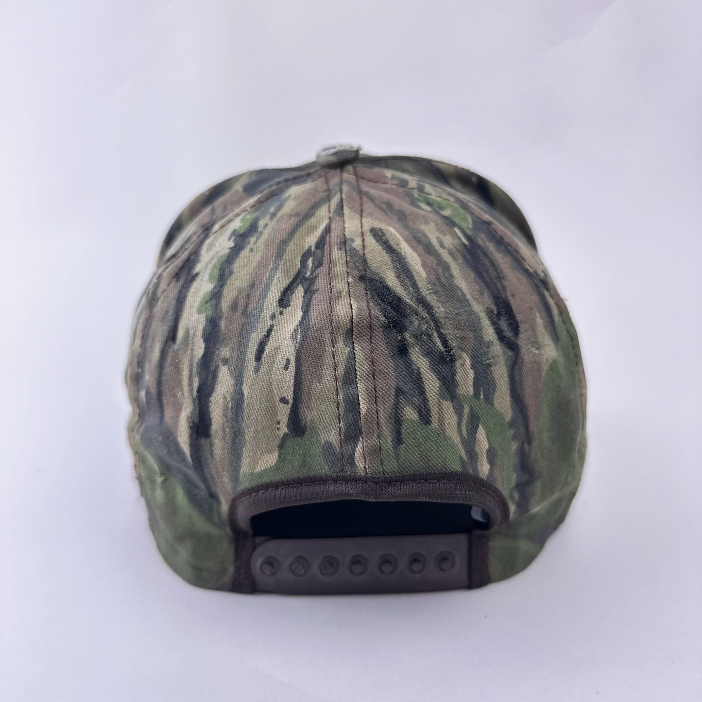 ASTROBOI* x Betz brown Real Tree camo doodle hat, rear view showing adjustable strap back.