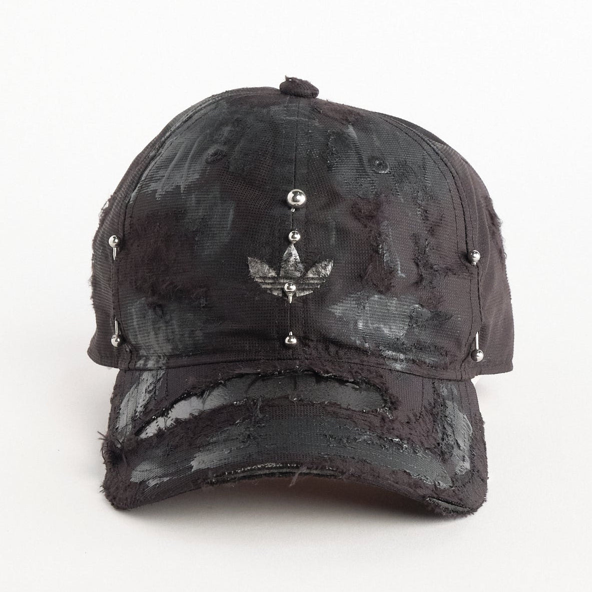 Front of Black Adidas hat customized by ASTROBOI* with distressing, black painted accents, and stainless steel piercings.