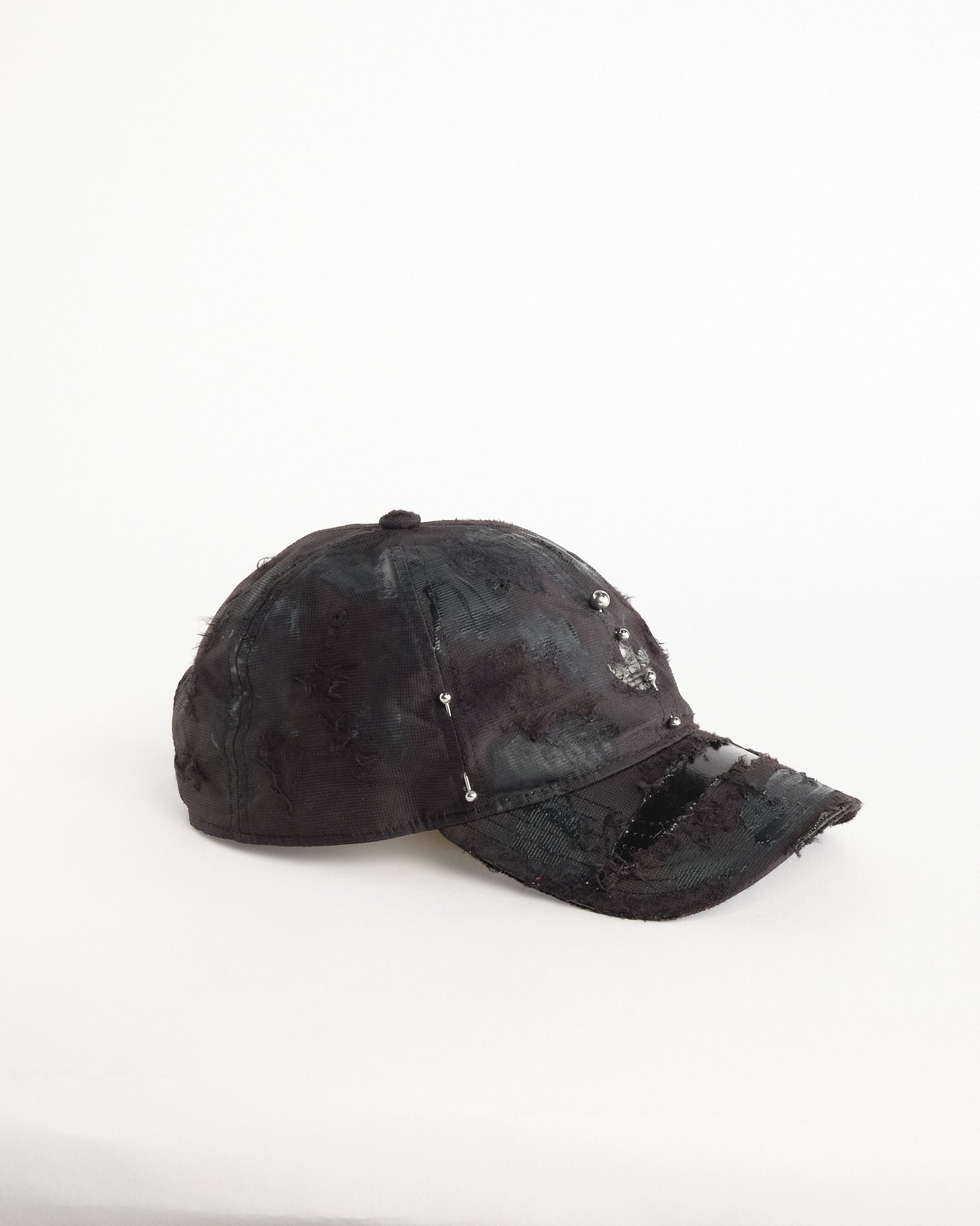 Right side of Black Adidas hat customized by ASTROBOI* with distressing, black painted accents, and stainless steel piercings.