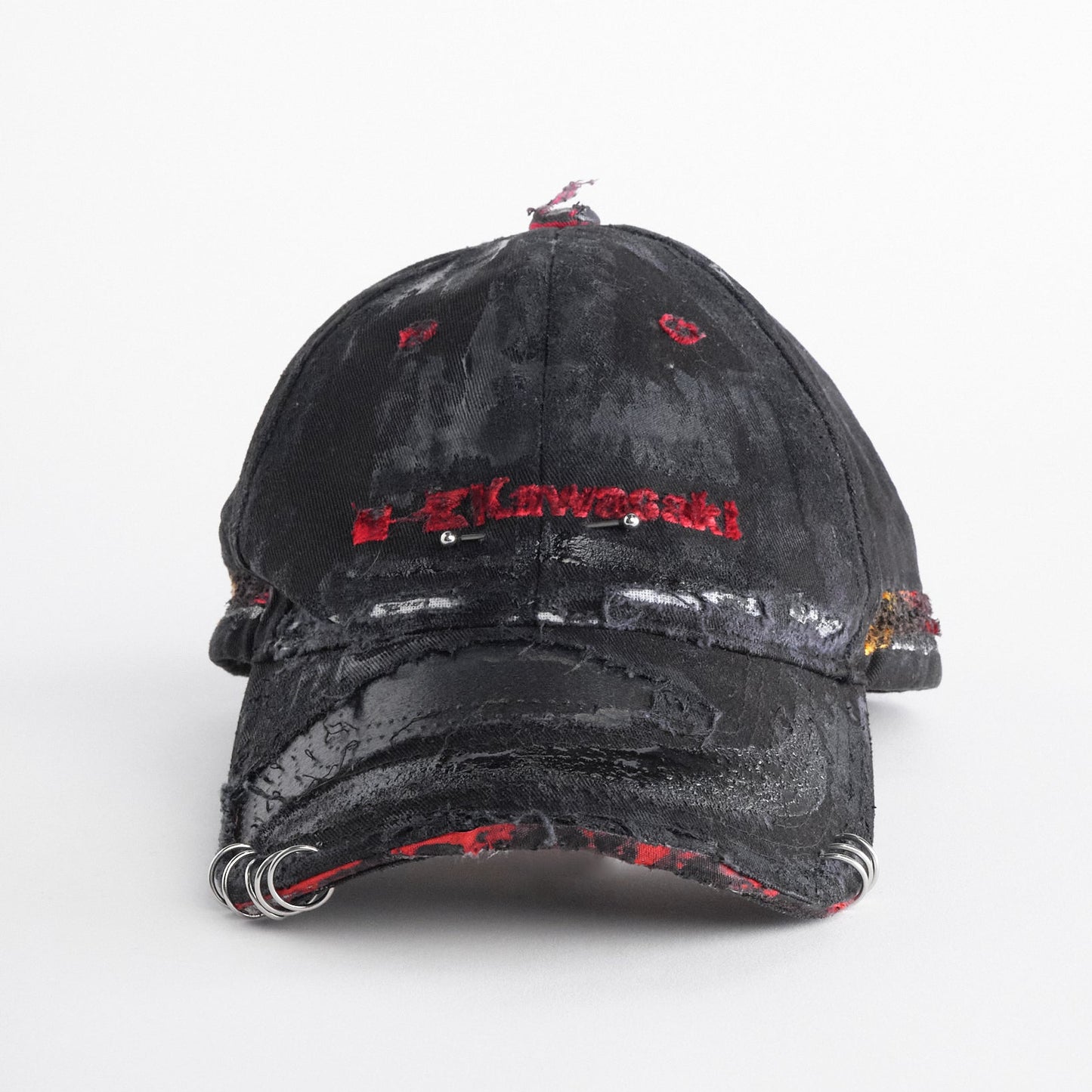 Front of ASTROBOI* x Kawasaki black distressed hat with pierced logo, deconstructed visor, stainless steel piercings, adjustable strap, handmade in NYC.