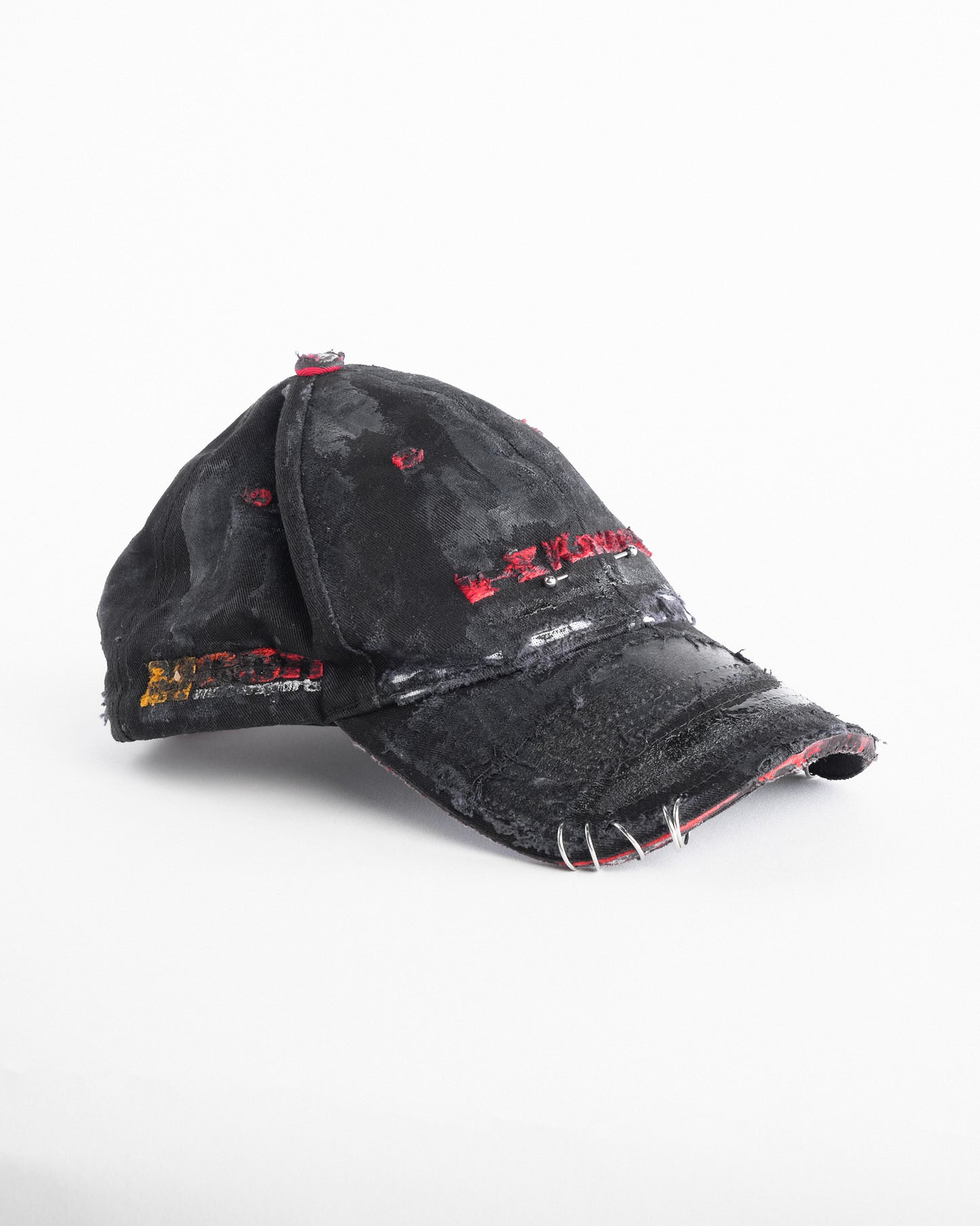 Right side of ASTROBOI* x Kawasaki black distressed hat with pierced logo, deconstructed visor, stainless steel piercings, adjustable strap, handmade in NYC.
