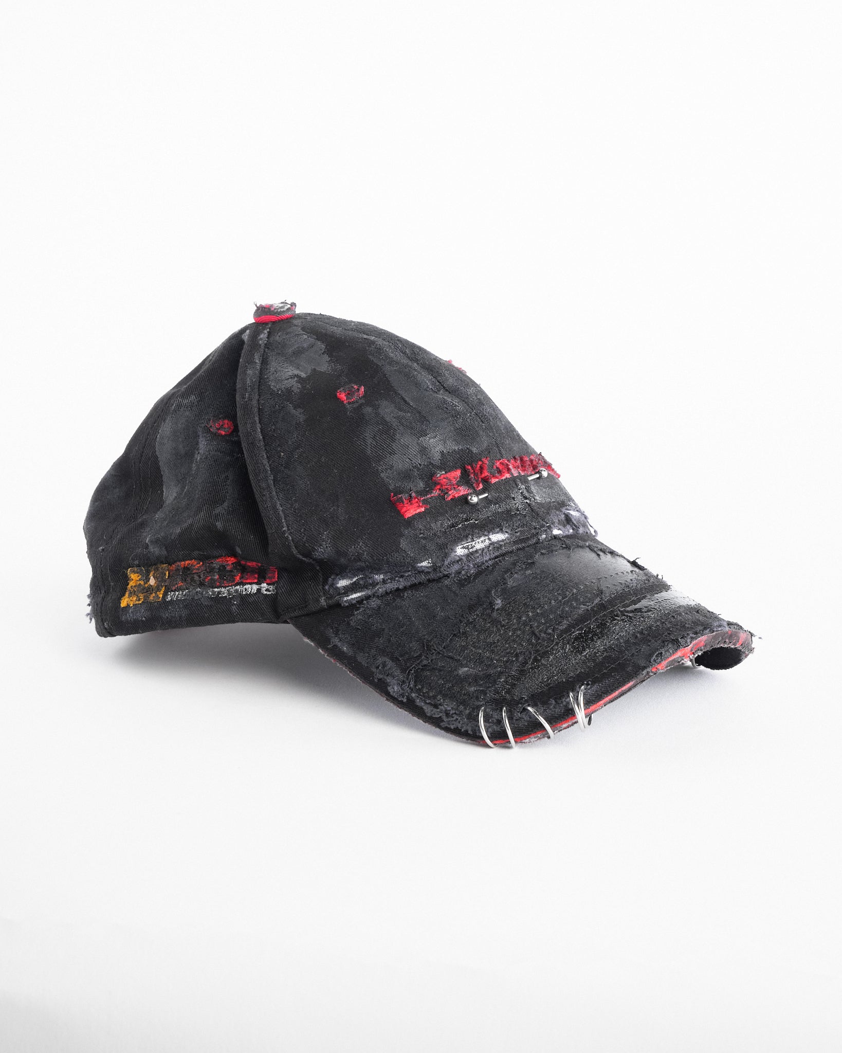 Right side of ASTROBOI* x Kawasaki black distressed hat with pierced logo, deconstructed visor, stainless steel piercings, adjustable strap, handmade in NYC.