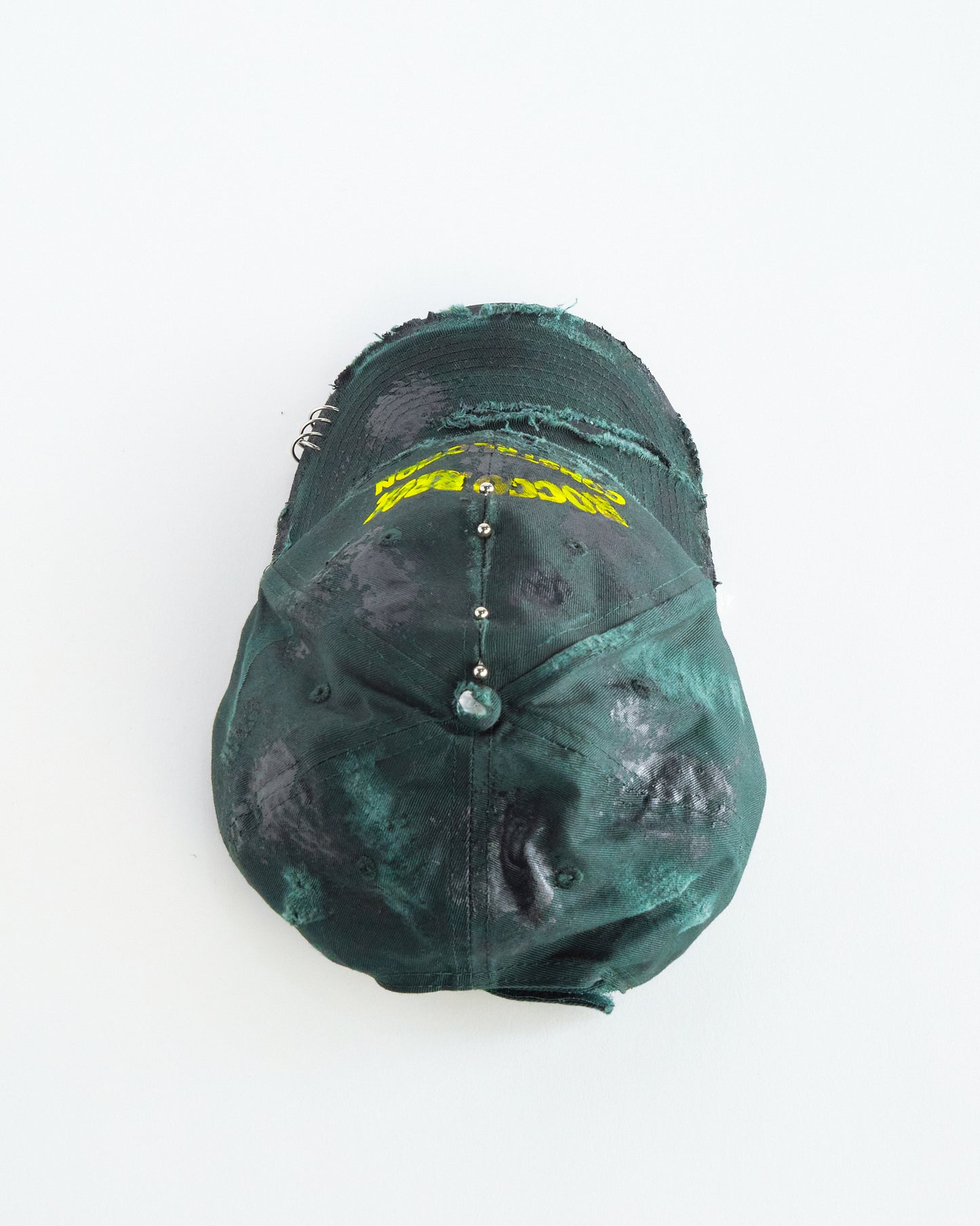 Top of ASTROBOI* Rocco Bros green construction hat with black grease distressing, stainless steel piercings, adjustable strap, handmade in NYC.