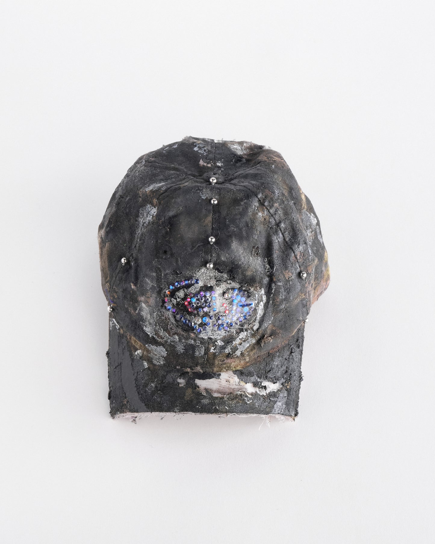 Overview of ASTROBOI* x Mossy Oak brown real tree camo half visor hat with rhinestone resin logo and stainless steel piercings.