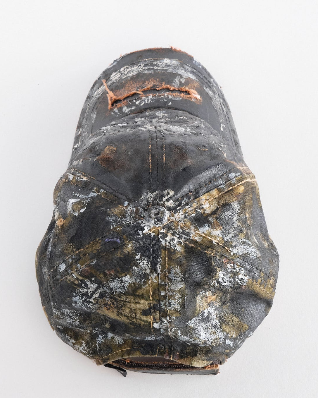 Back top of of ASTROBOI* x Mossy Oak brown RealTree camo hat with rhinestones, distressed paint details, and leather visor, adjustable fit.