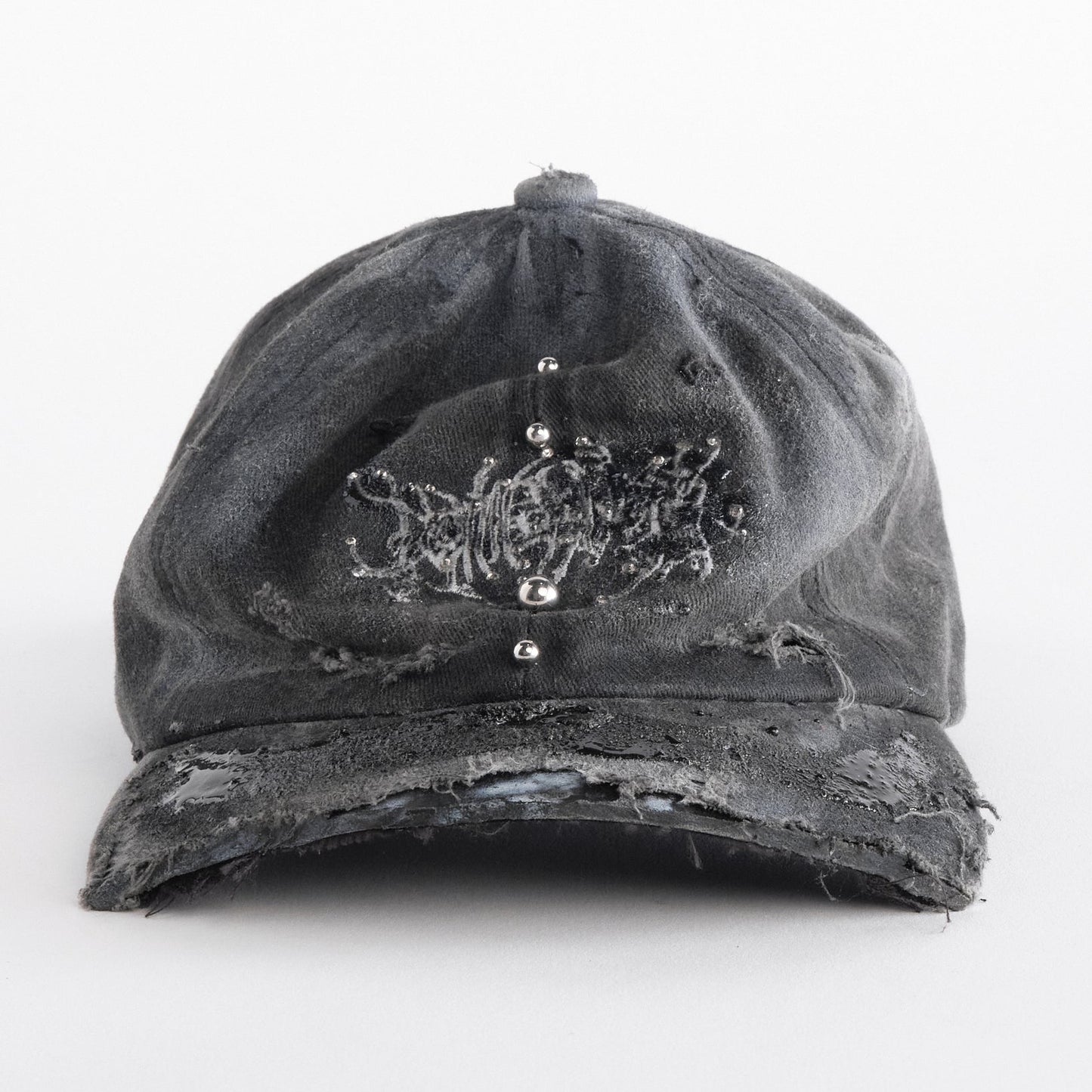 Front side of ASTROBOI* Chalk black distressed half-visor hat with white airbrush detailing, rhinestones, resin accents, and stainless steel piercings.