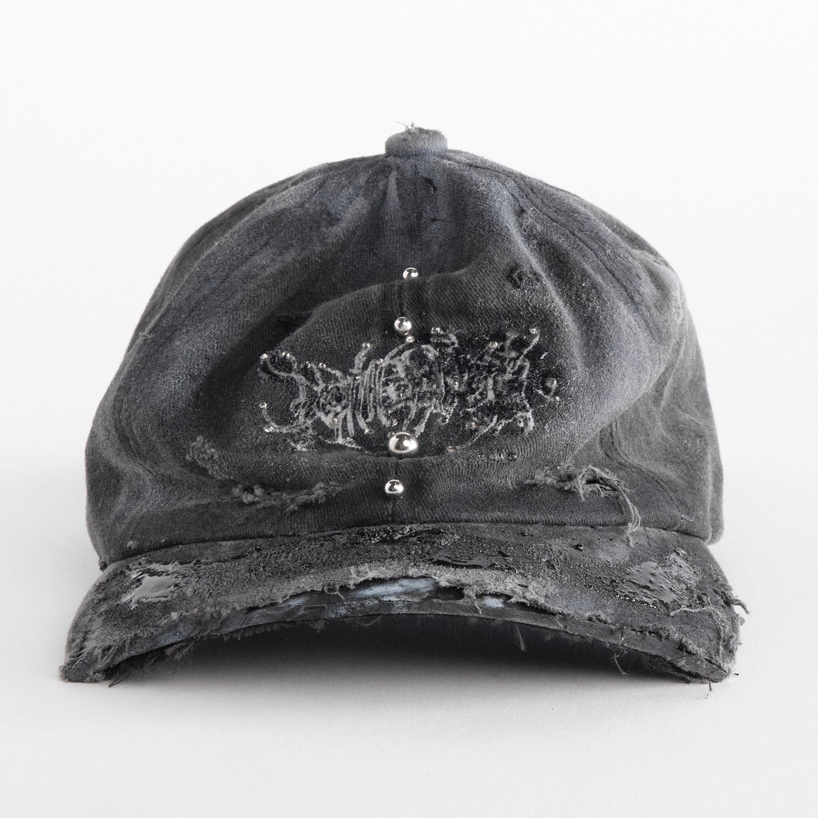Front side of ASTROBOI* Chalk black distressed half-visor hat with white airbrush detailing, rhinestones, resin accents, and stainless steel piercings.