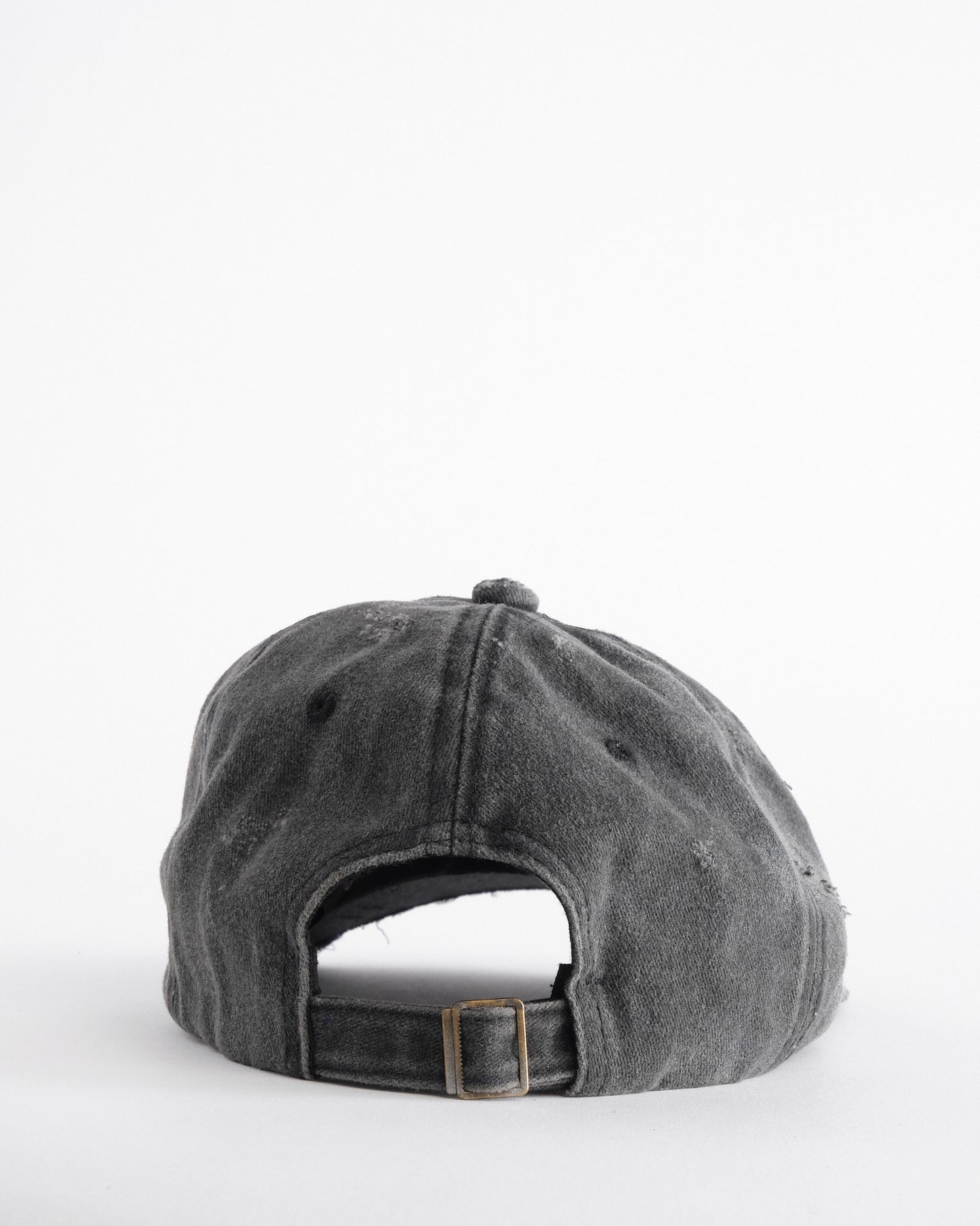 Back side of ASTROBOI* Chalk black distressed half-visor hat with white airbrush detailing, rhinestones, resin accents, and stainless steel piercings.