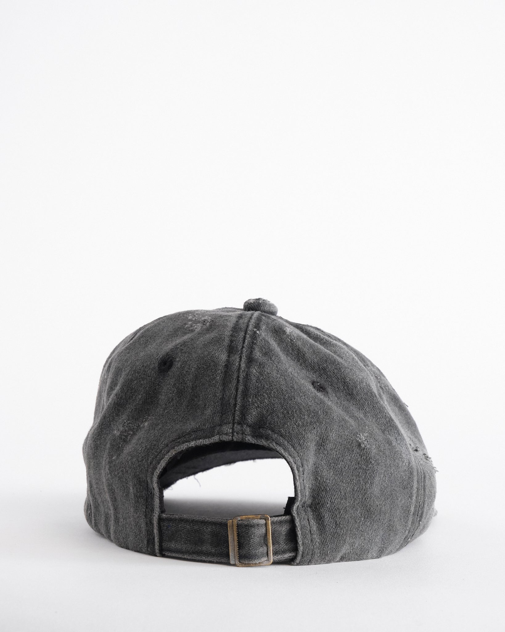 Back side of ASTROBOI* Chalk black distressed half-visor hat with white airbrush detailing, rhinestones, resin accents, and stainless steel piercings.