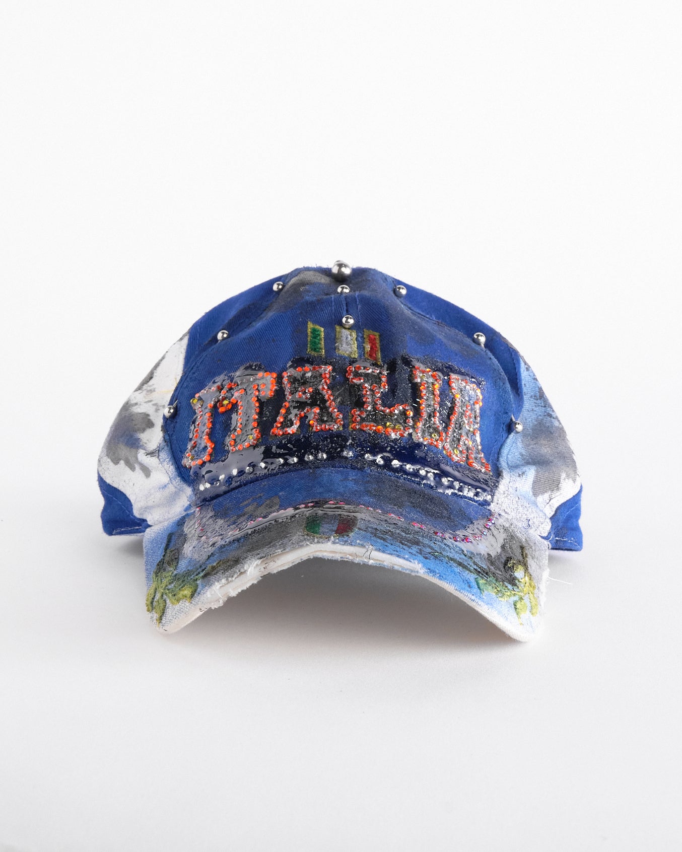 Front of Upcycled blue and white ASTROBOI* ‘ITALIA’ hat with rhinestones, resin, custom paint, and stainless steel piercings, handcrafted in NYC.