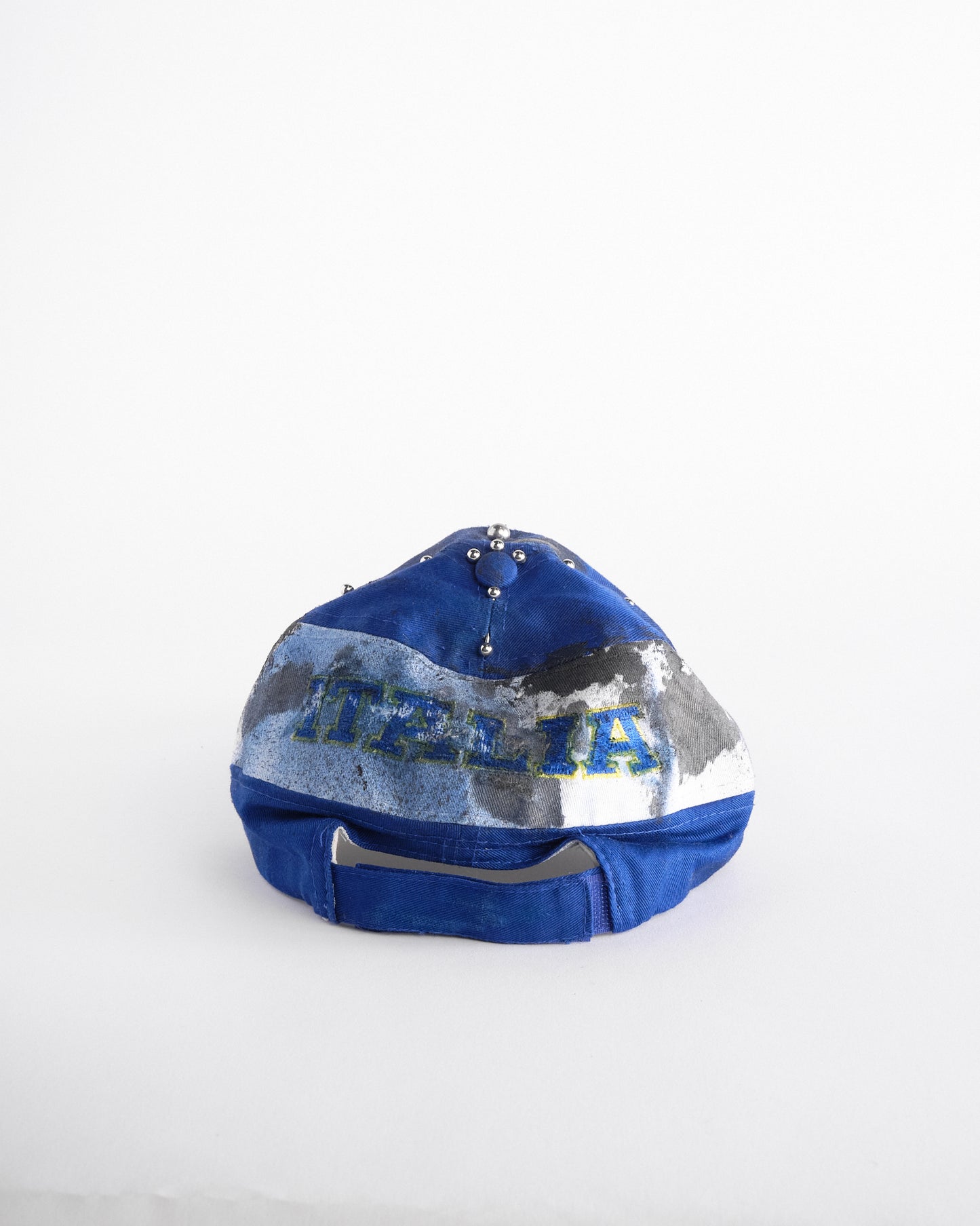 Back of Upcycled blue and white ASTROBOI* ‘ITALIA’ hat with rhinestones, resin, custom paint, and stainless steel piercings, handcrafted in NYC.