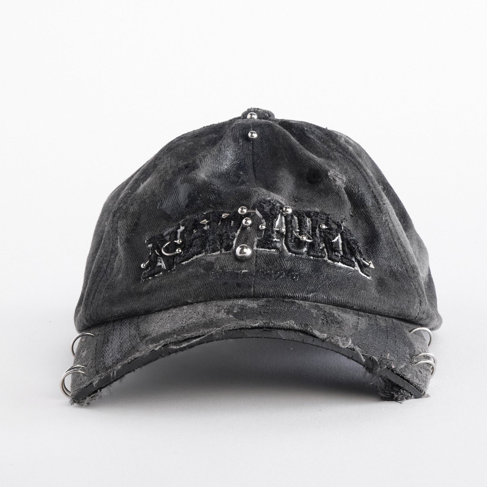 Front of Black half-visor “New York” hat with embroidered front logo, stainless steel piercings, and an adjustable strap.