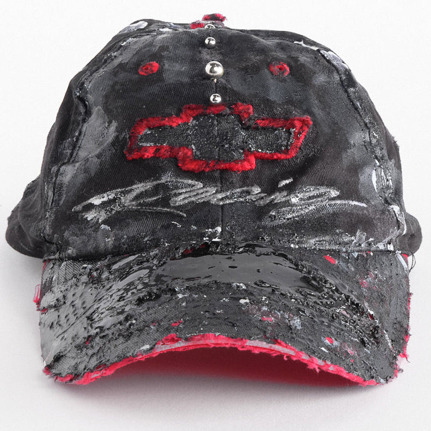 Front of of Black and red Chevy Racing hat customized by ASTROBOI* with distressing, painted details, glossy resin visor, and stainless steel piercings.