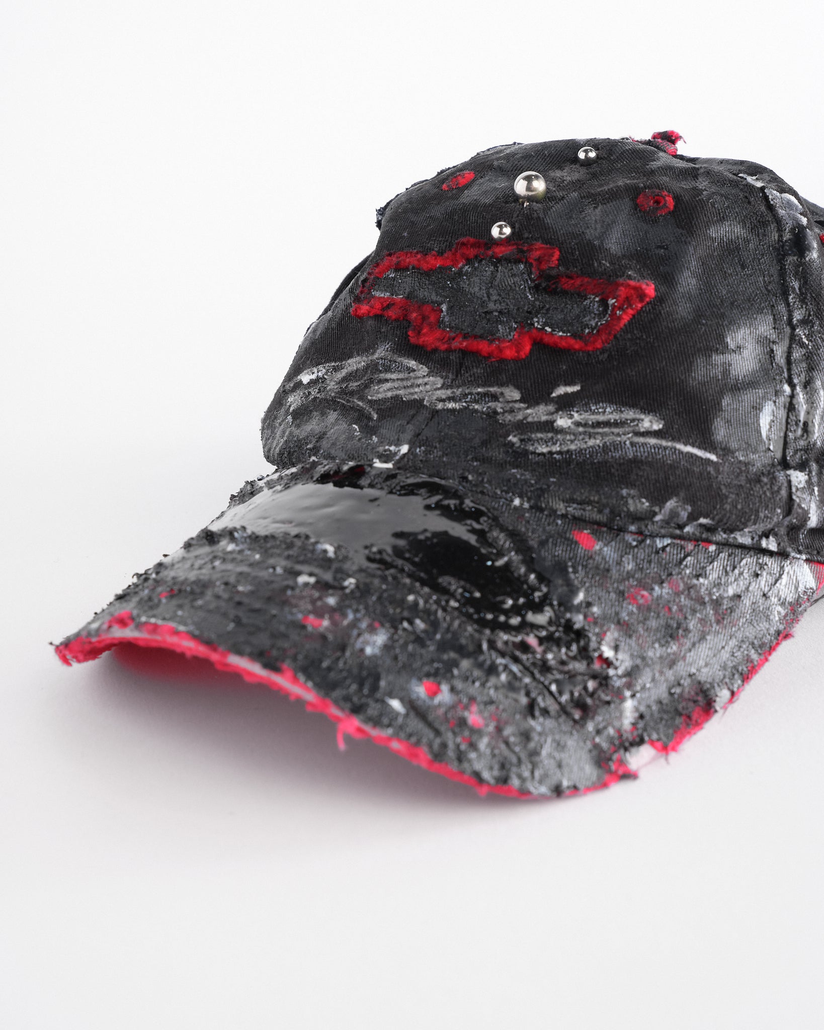 Visor detail of Black and red Chevy Racing hat customized by ASTROBOI* with distressing, painted details, glossy resin visor, and stainless steel piercings.
