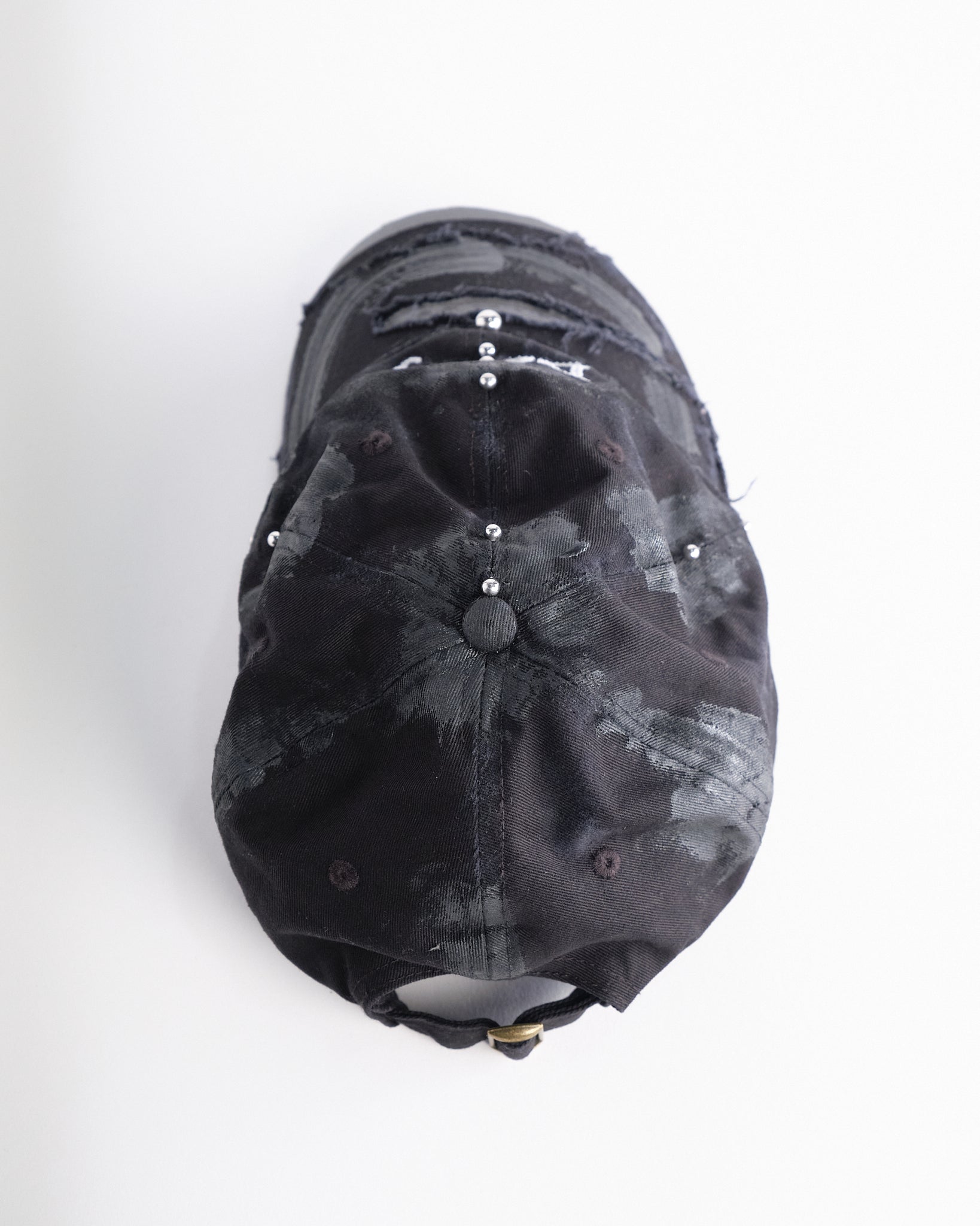 Top of Black distressed ASTROBOI* ‘Daddy’ hat with custom paint detailing and stainless steel piercings, handcrafted in NYC.