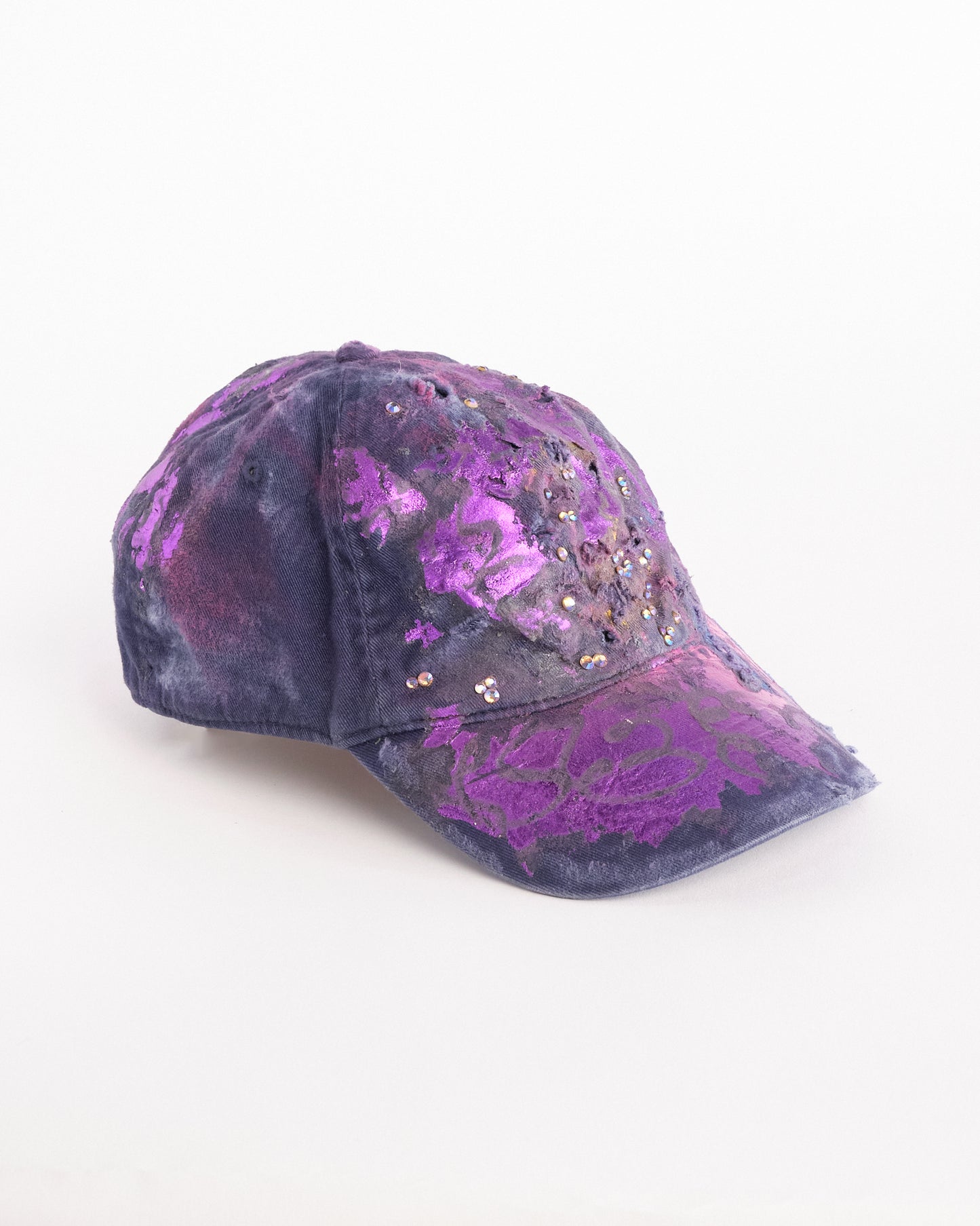 Right side of ASTROBOI* x Bauer purple distressed hat with metallic paint detailing, clustered rhinestones, and closed-back fit, handmade and customized in NYC.