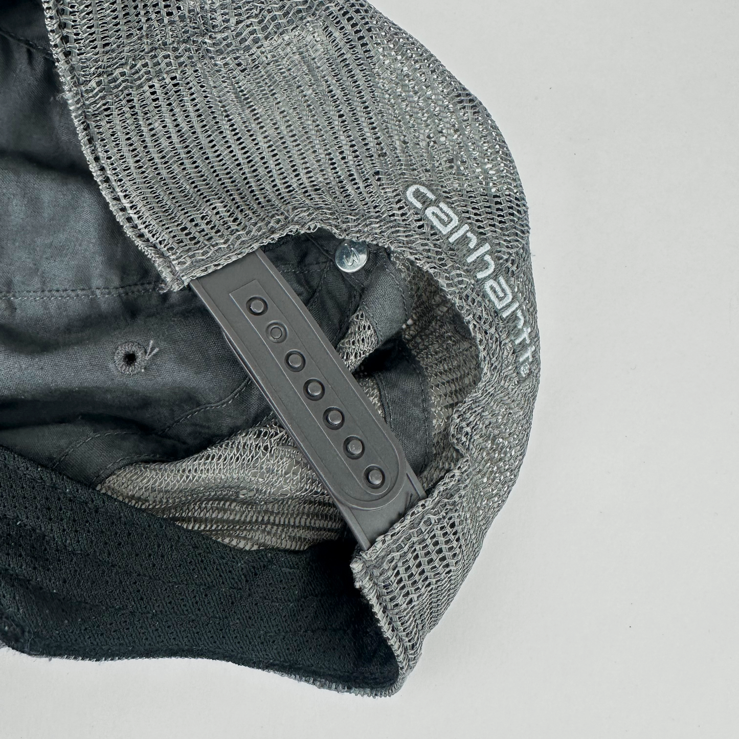 ASTROBOI* x Carhartt 'Amethyst' gray and purple distressed studded hat, close up of rear view showing frayed mesh back panel and adjustable strap.
