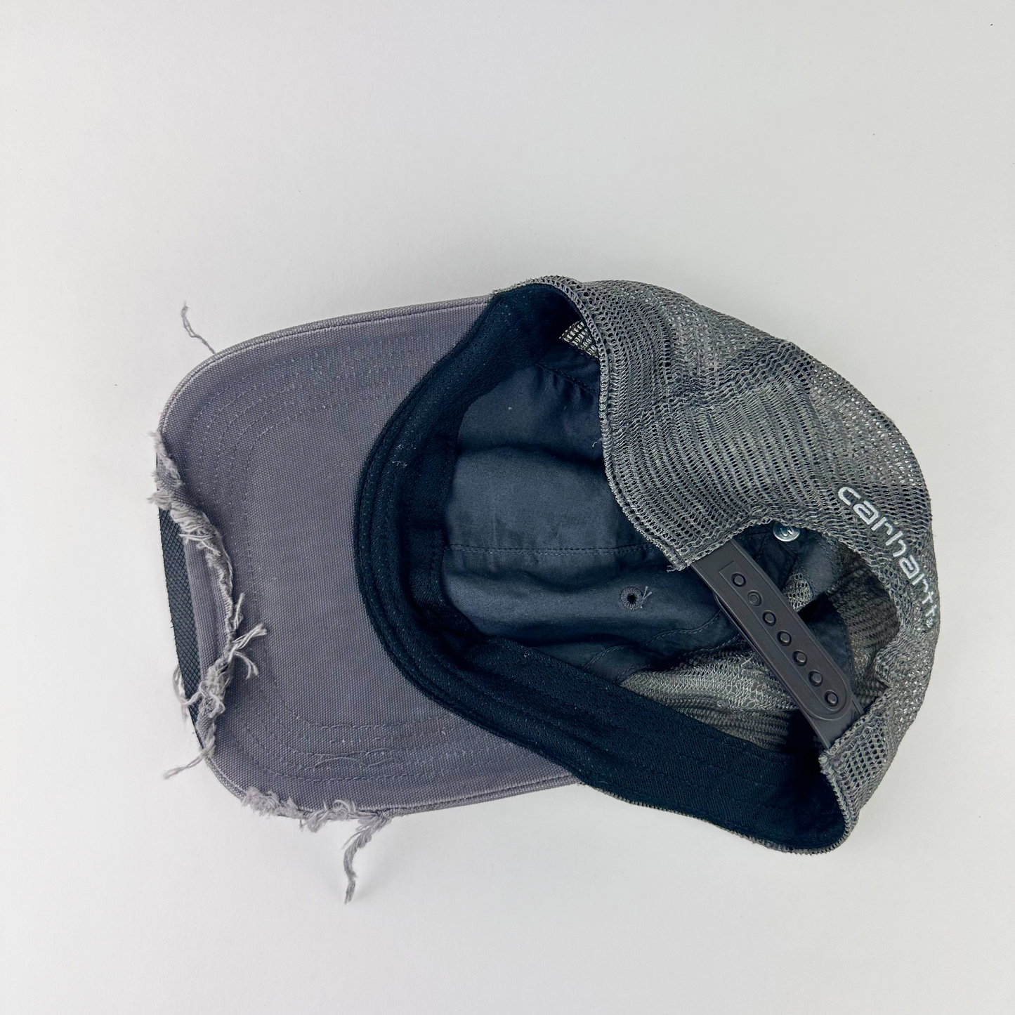 ASTROBOI* x Carhartt 'Amethyst' gray and purple distressed studded hat, rear view showing frayed mesh back panel and adjustable strap.